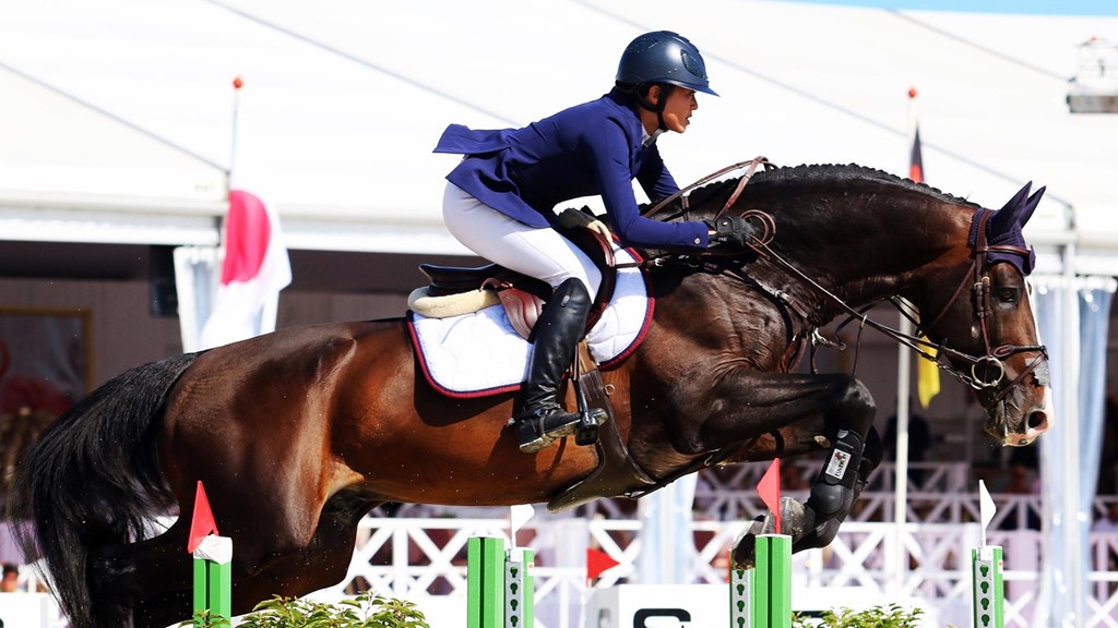 Jasmine Chen and horse jump during a competition.