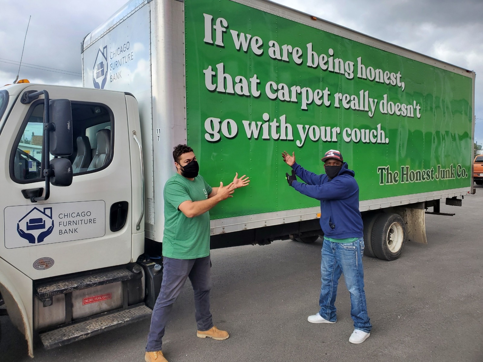 Honest Junk truck with two people posing outside of it. Truck reads "If we are being honest, that carpet doesn't go with your couch"
