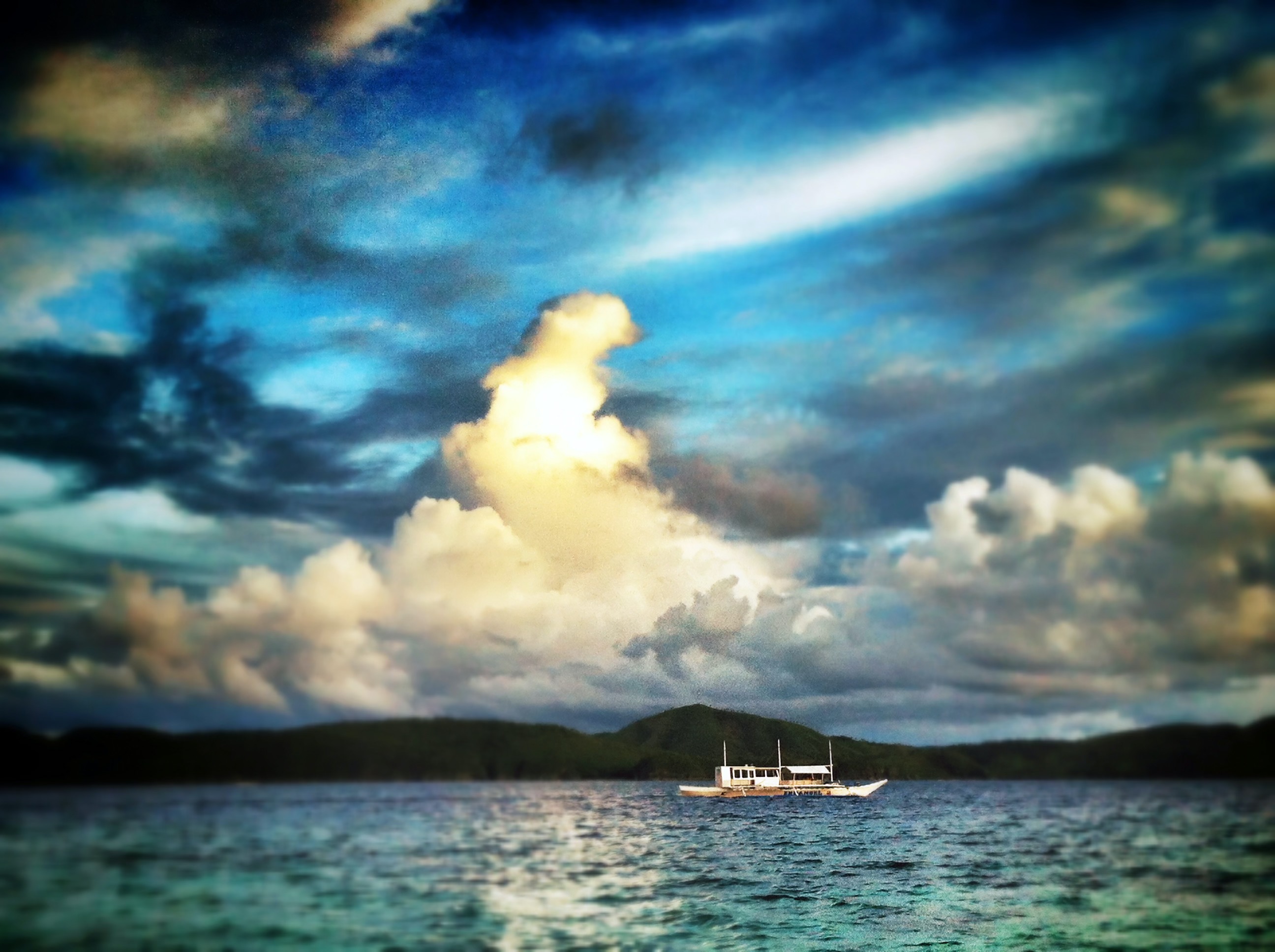 Palawan seascape and boat with clouds in distance