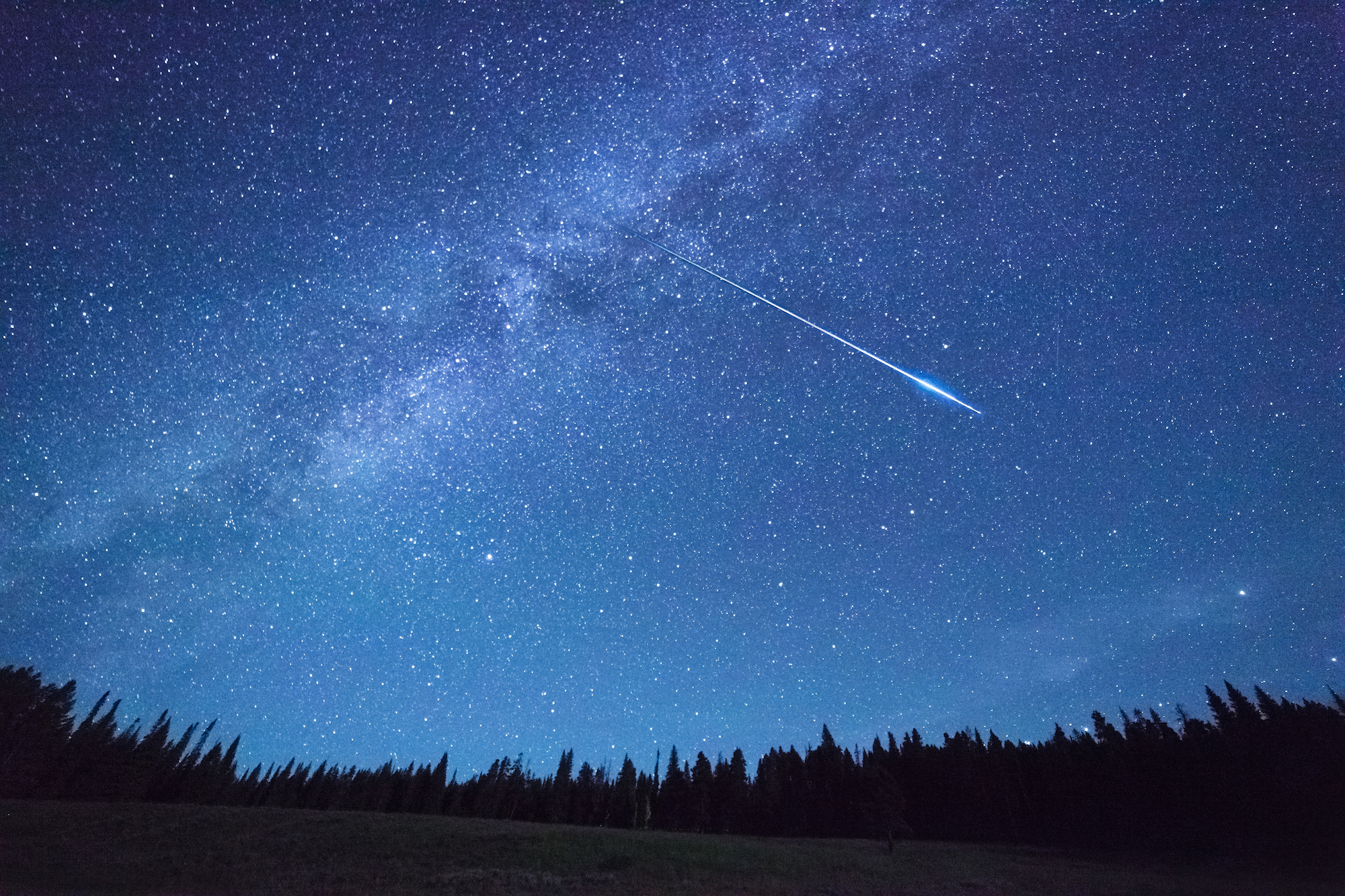 meteor streaks across a night sky