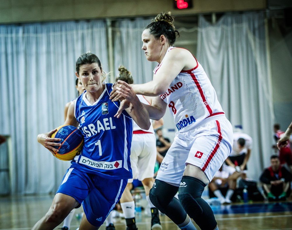 Alyssa Baron, playing for Israel, makes a strong move to the basketball against Switzerland.