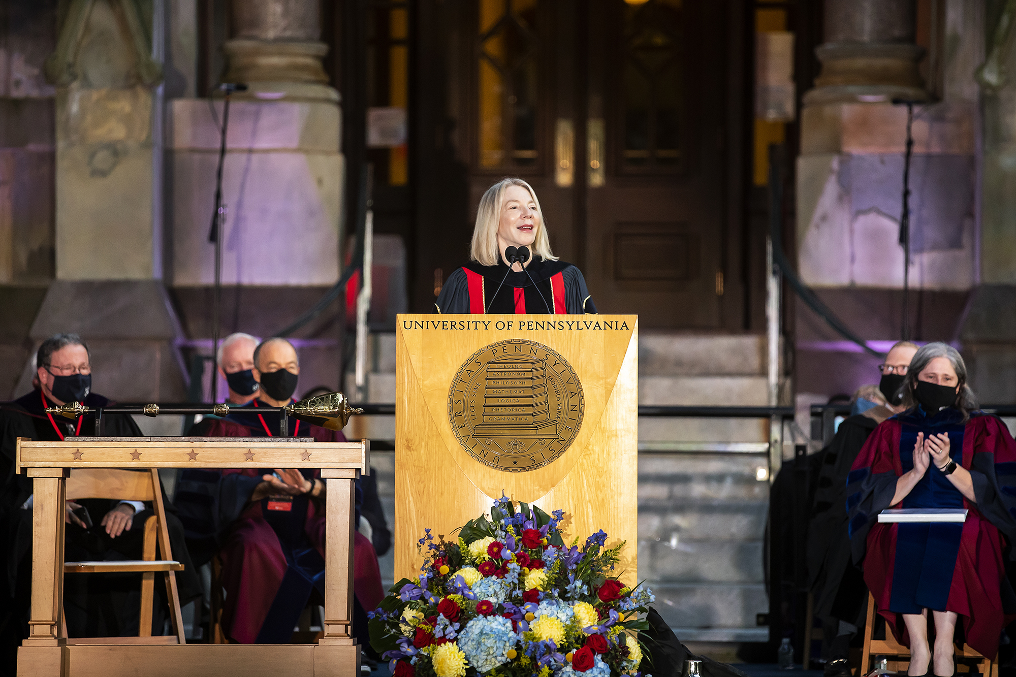 Amy Gutmann speaks at a podium during Convocation in front of College Hall.