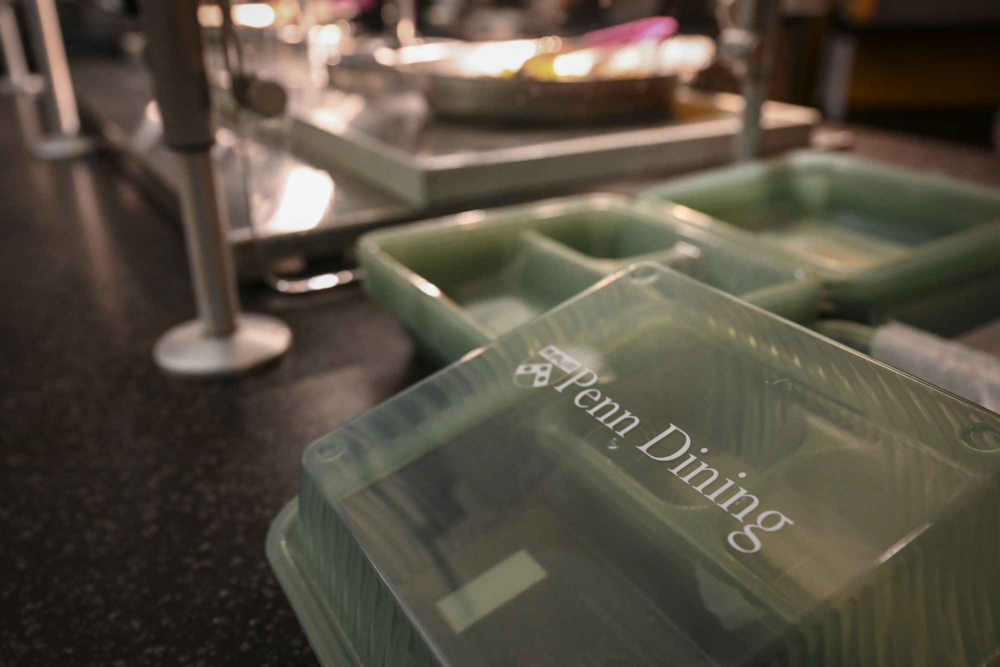close-up of reusable plastic Penn Dining containers on counter