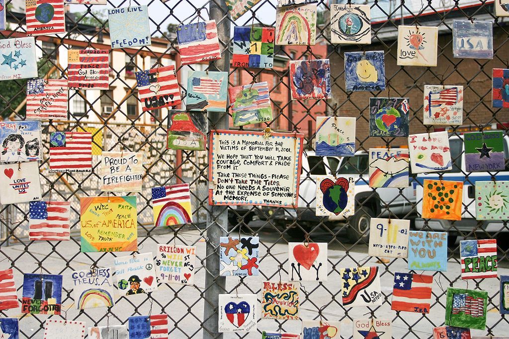 fence with flags and september 11 notes