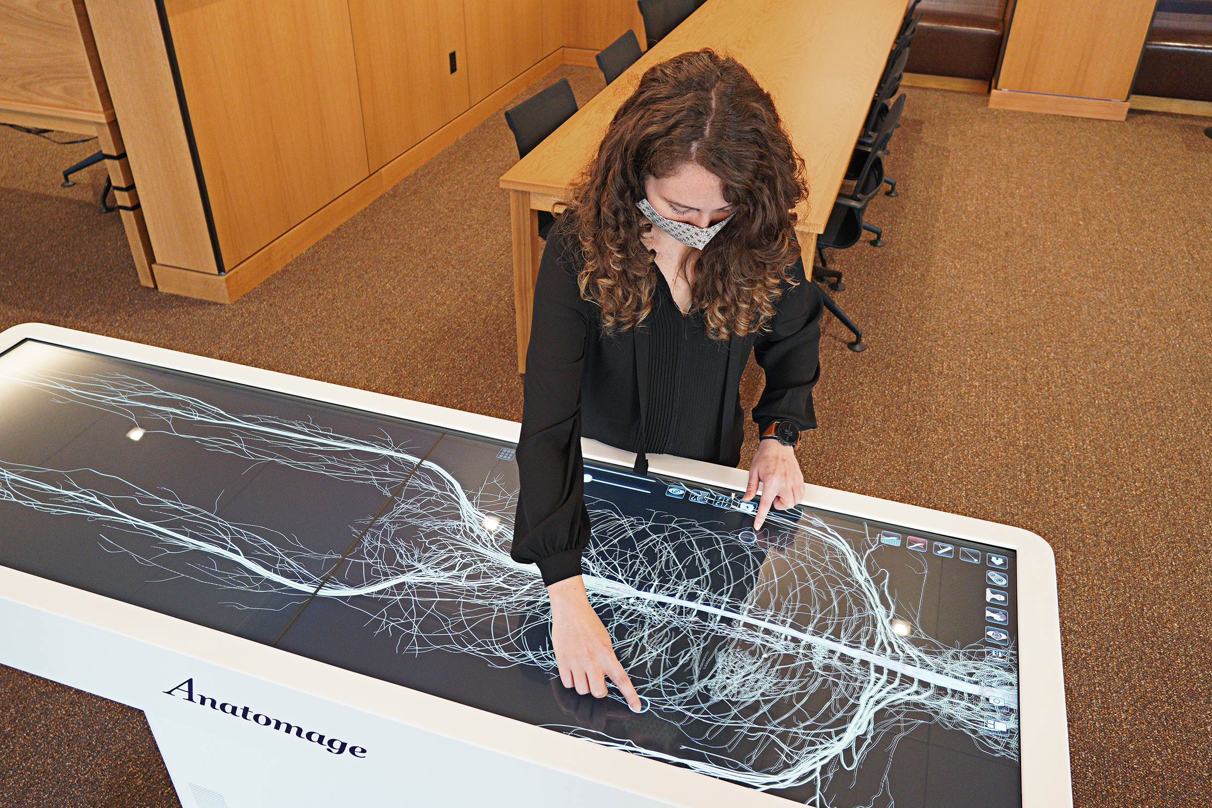 Person at a table with an image of a skeleton