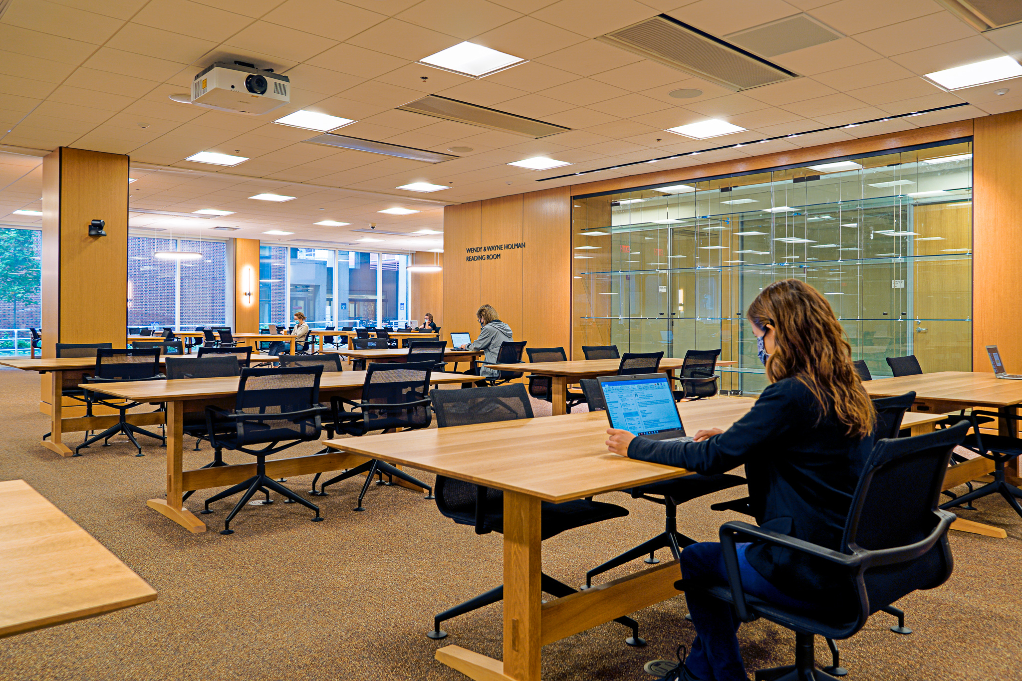 person sitting at laptop in new library space