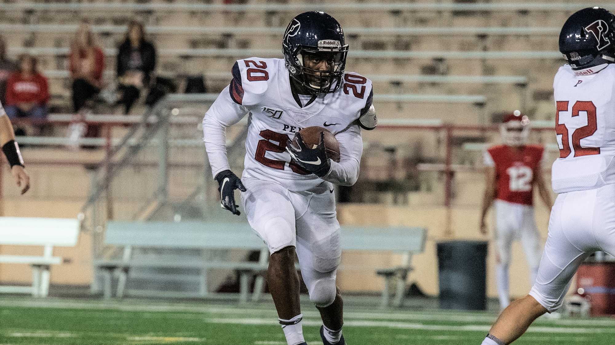 Senior running back Laquan McKever carries the ball past blockers.