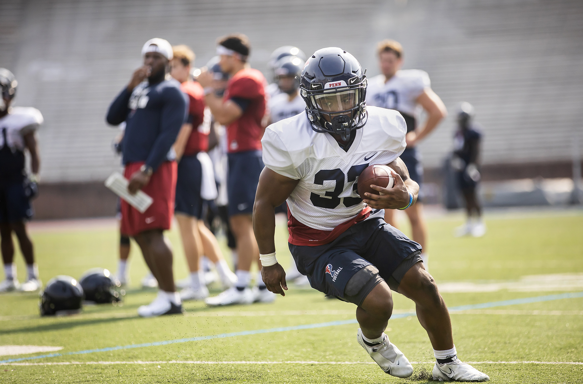 A running back runs through drills during practice at Franklin Field.