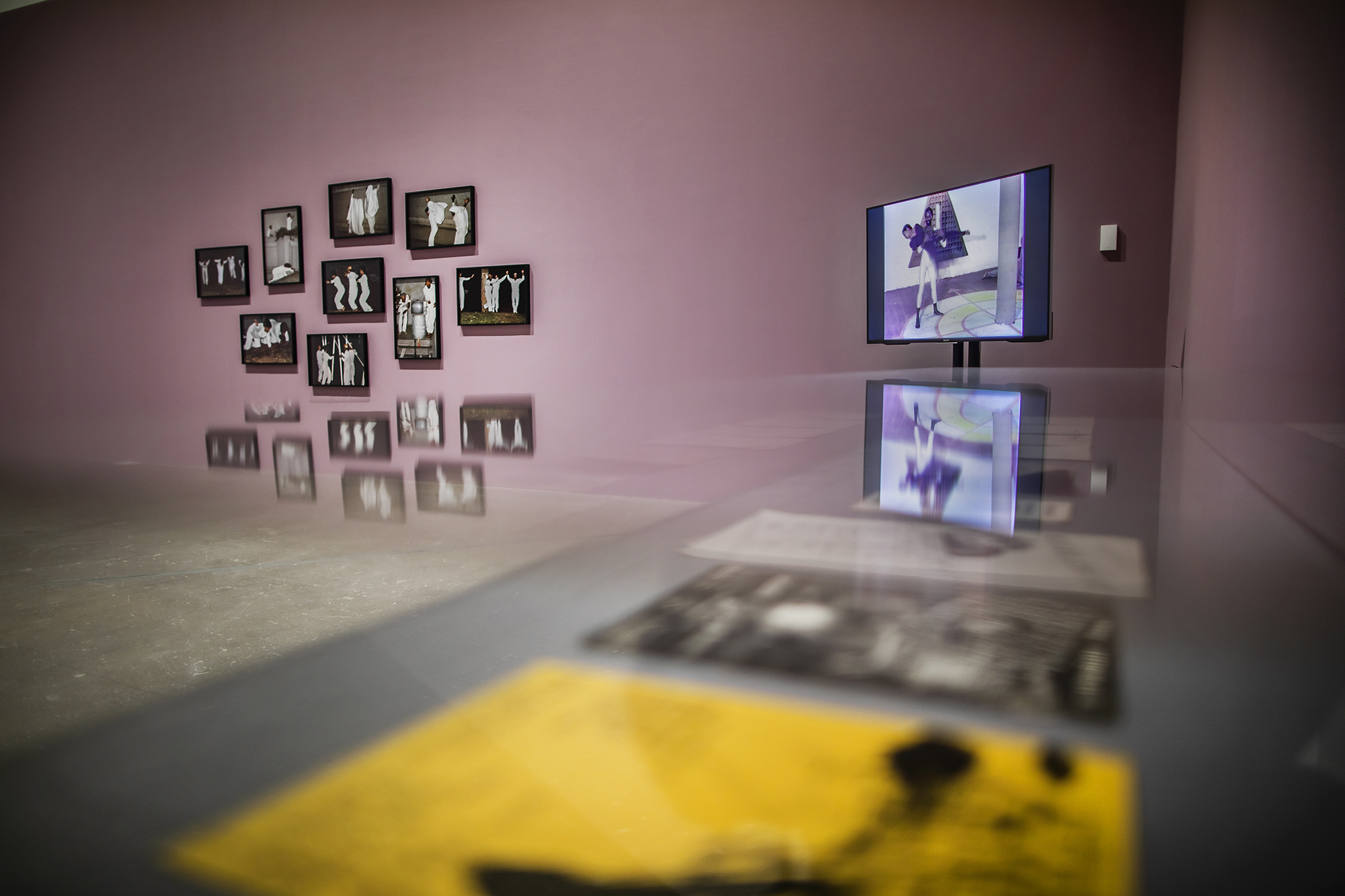 Video screen and photographs hung on a wall