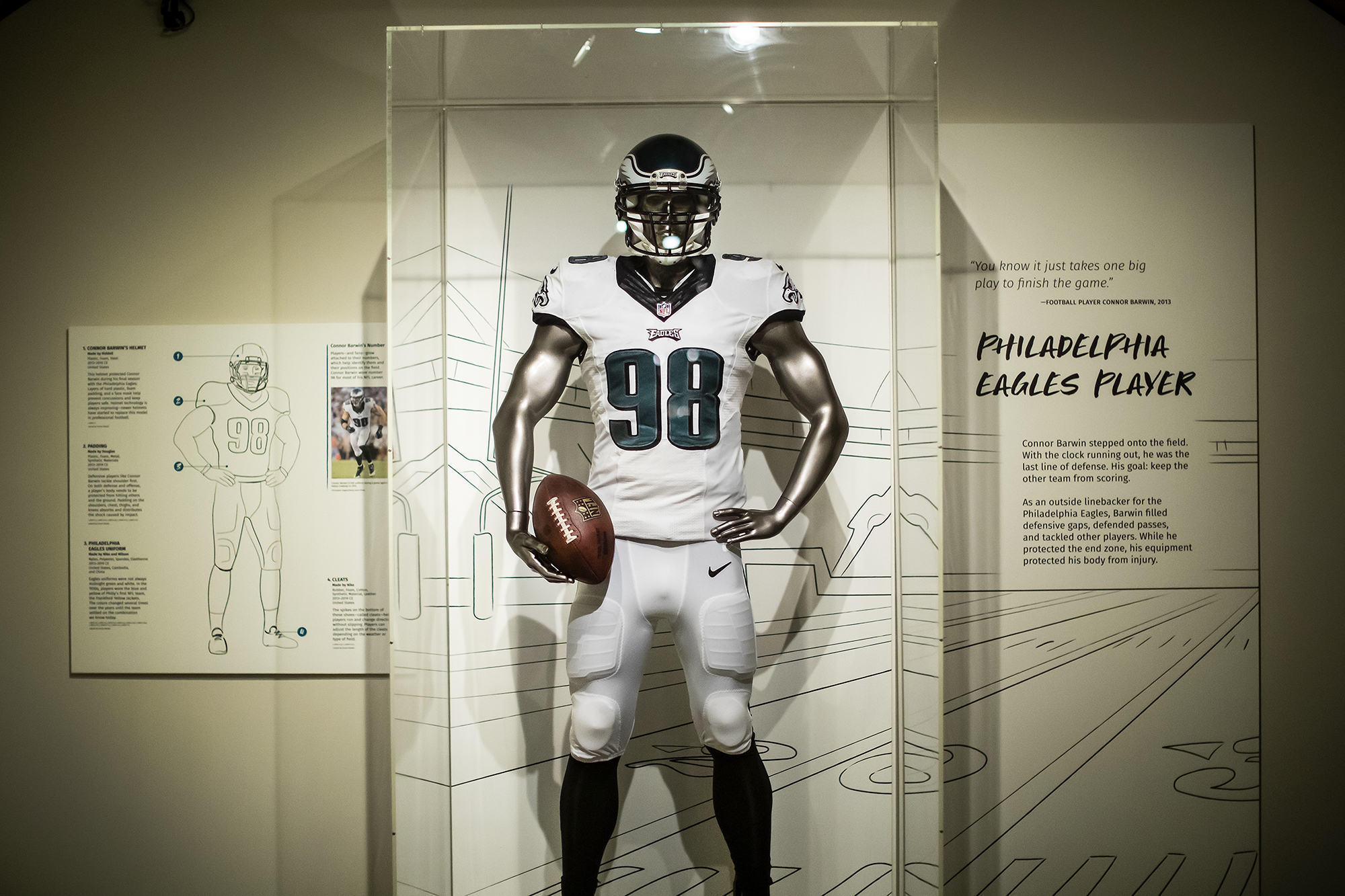 football uniform on a mannequin in a glass case