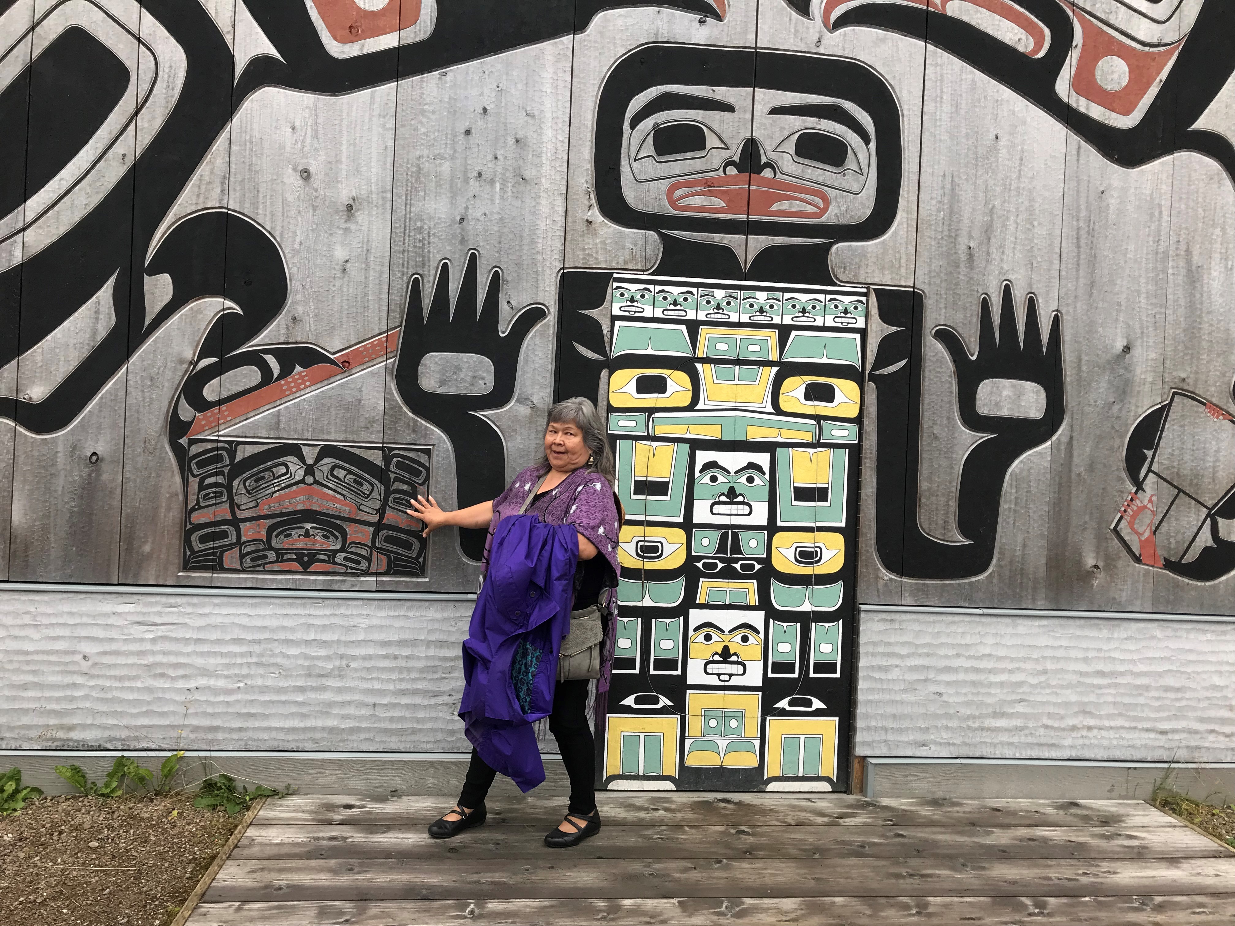 Woman in front of totem 