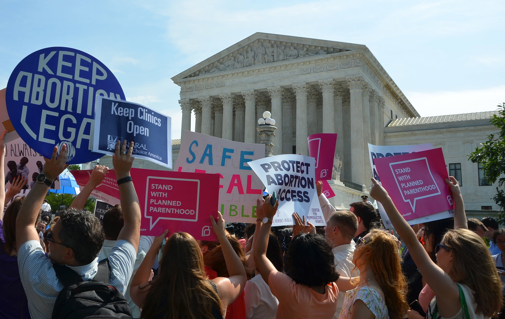 Pro-choice activists hold signs reading "keep abortion legal' and "protect abortion access' in front of the US Supreme Court building