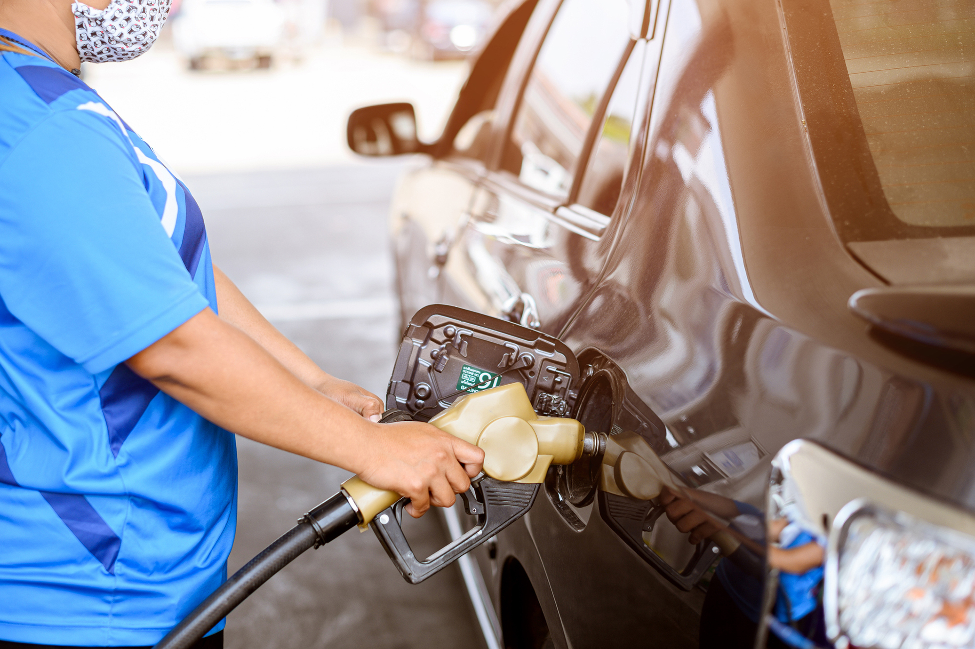 person pumping gas into a car