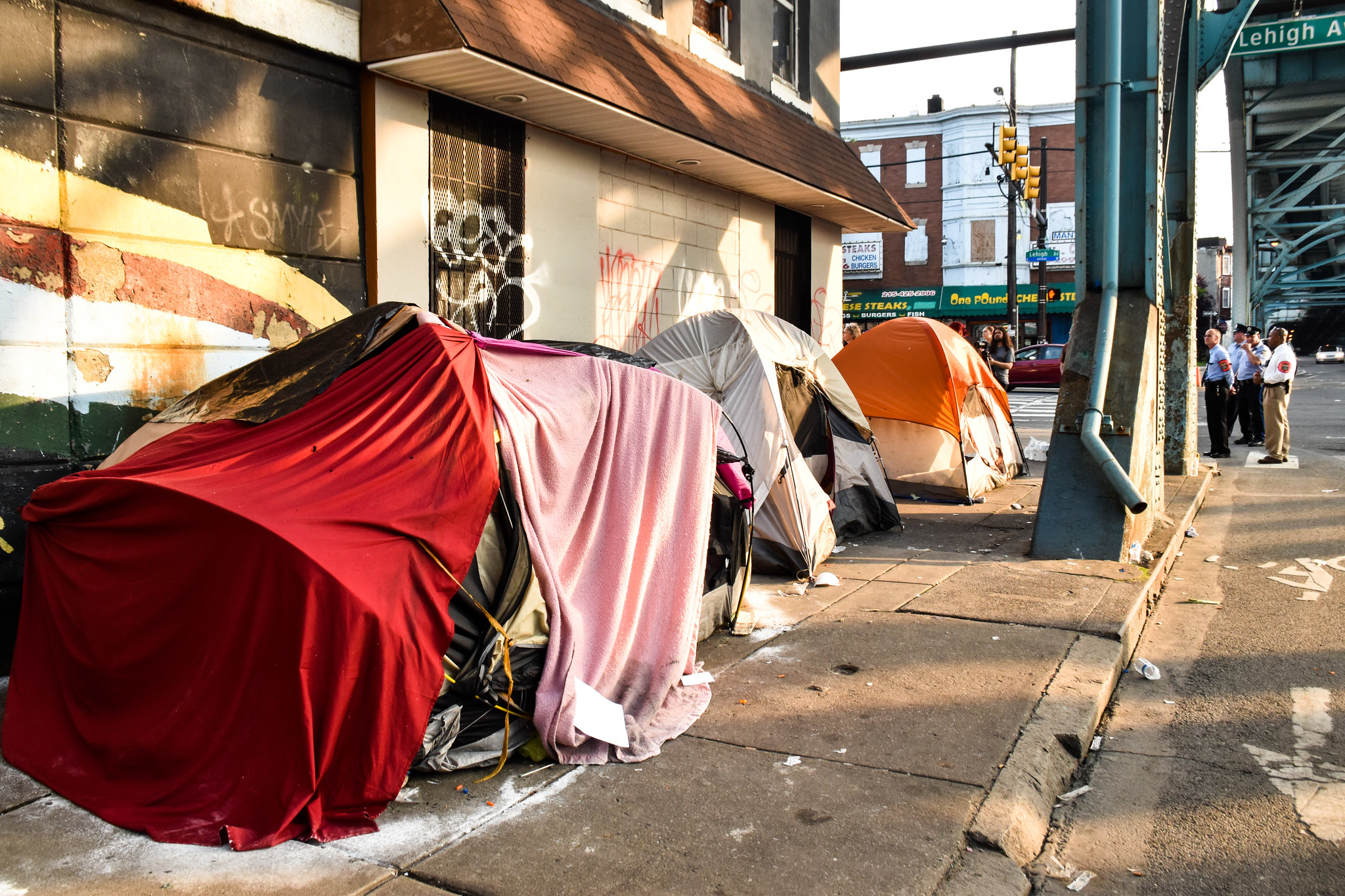 Several tents making up a homeless encampment on a Philadelphia sidewalk. 