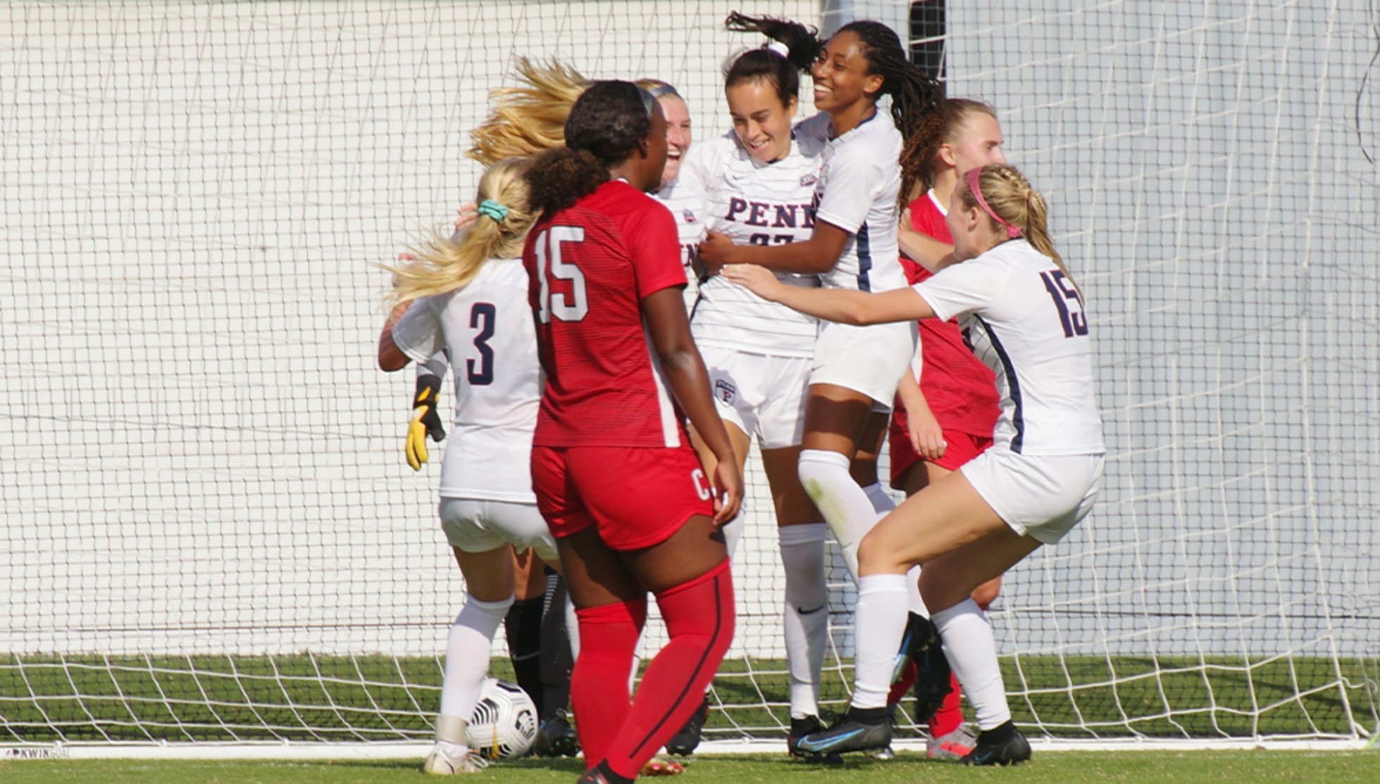 Members of the women's soccer team celebrate after scoring a goal against Cornell at Rhodes Field.