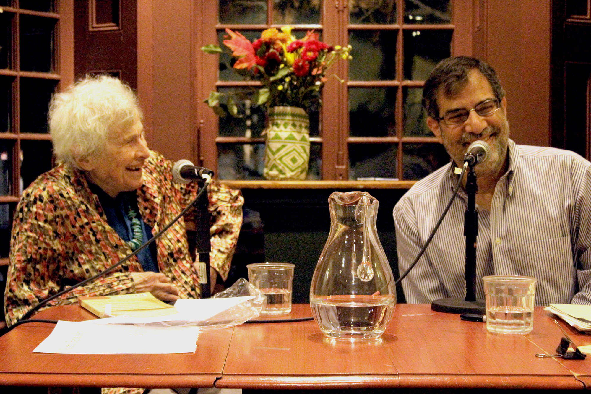 Naomi Replansky and Al Filreis sit at a table at the Kelly Writers House.