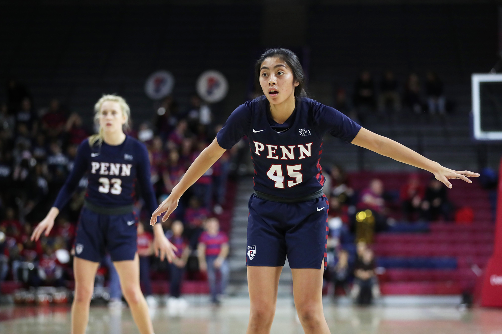 Padilla, playing defense, stands with her arms outstretched at center court.