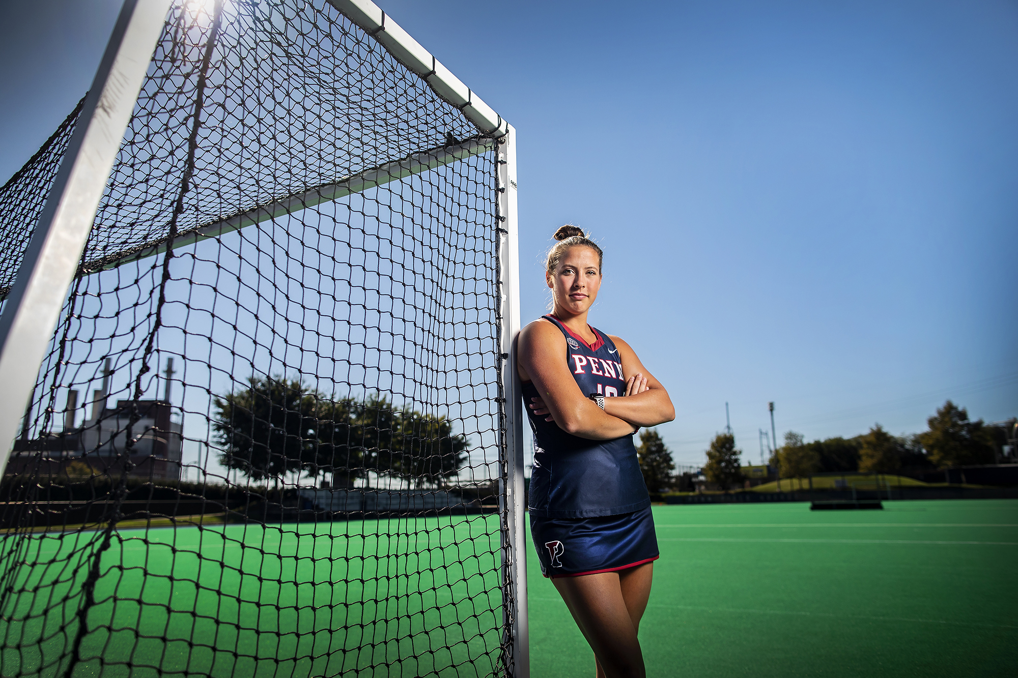 Gracyn Banks leans up against the goalpost at Valgelos Field with her arms folded.