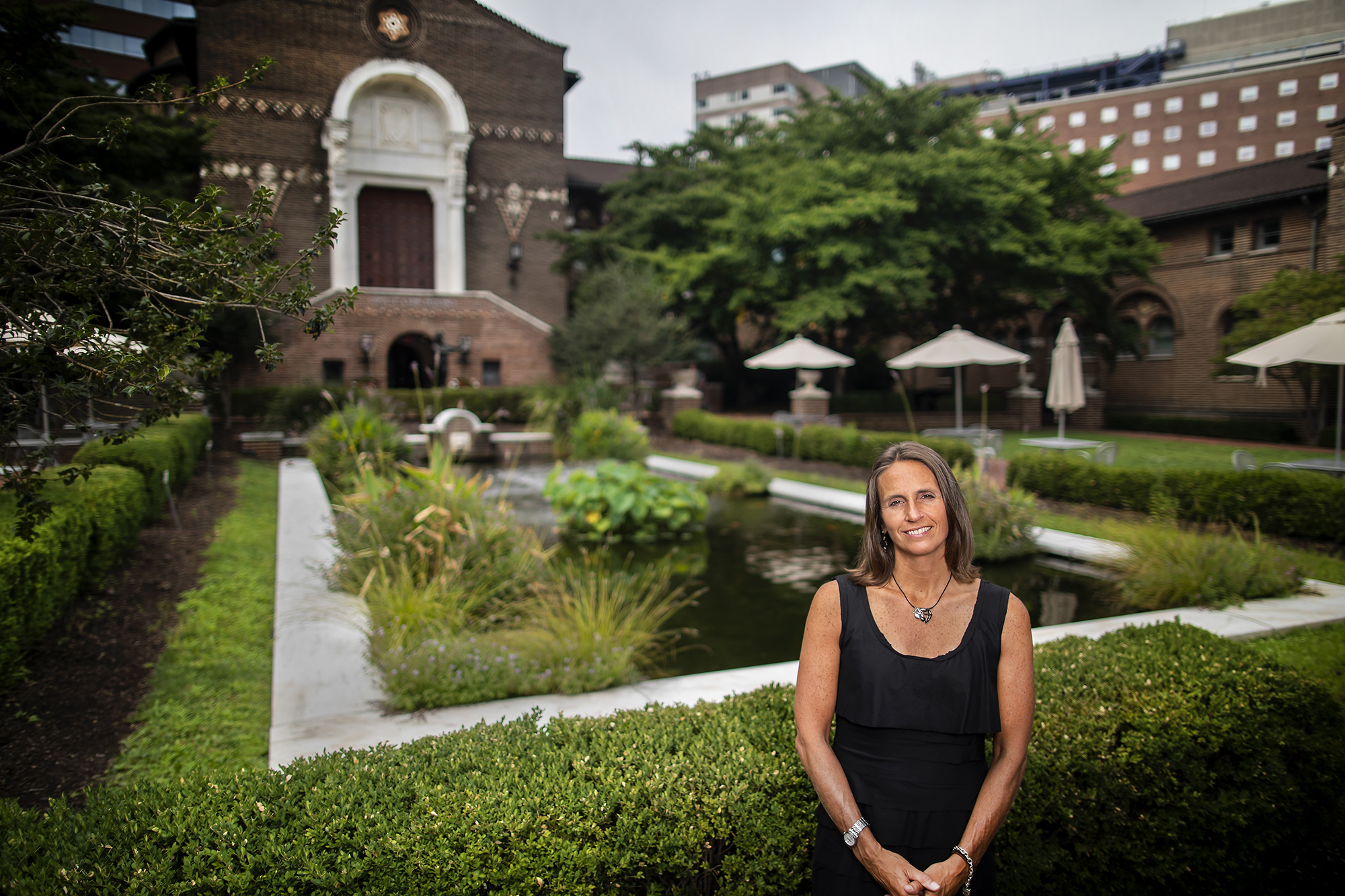Alanna Shanahan posts in front of the garden at the entrance to the Penn Museum on Spruce Street.