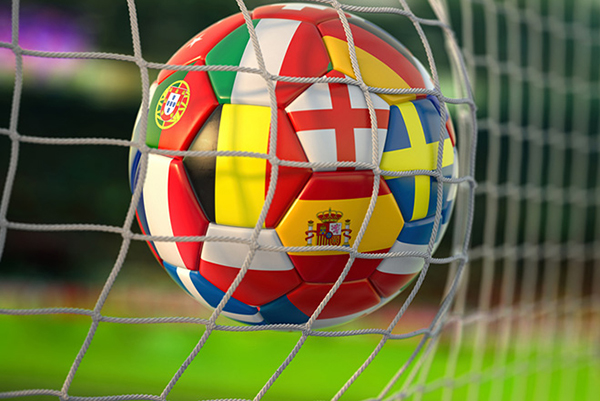 Soccer ball landing against the back of a goal net.