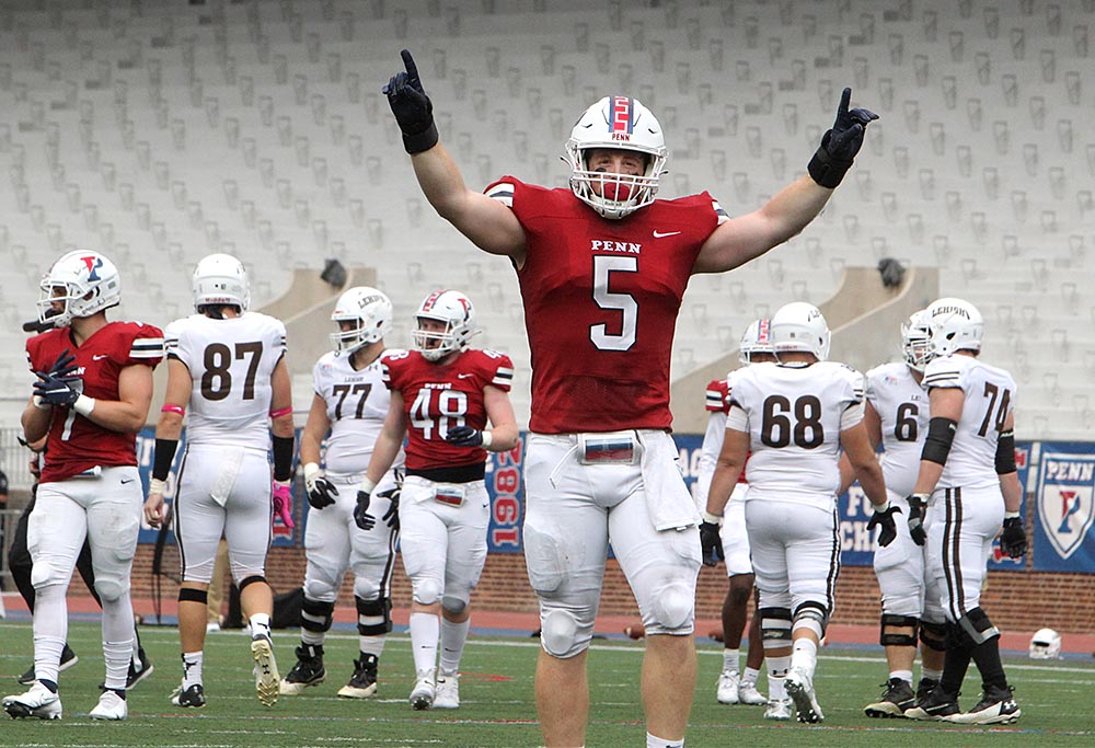 O'Neill raises his arms up high after making a big play.