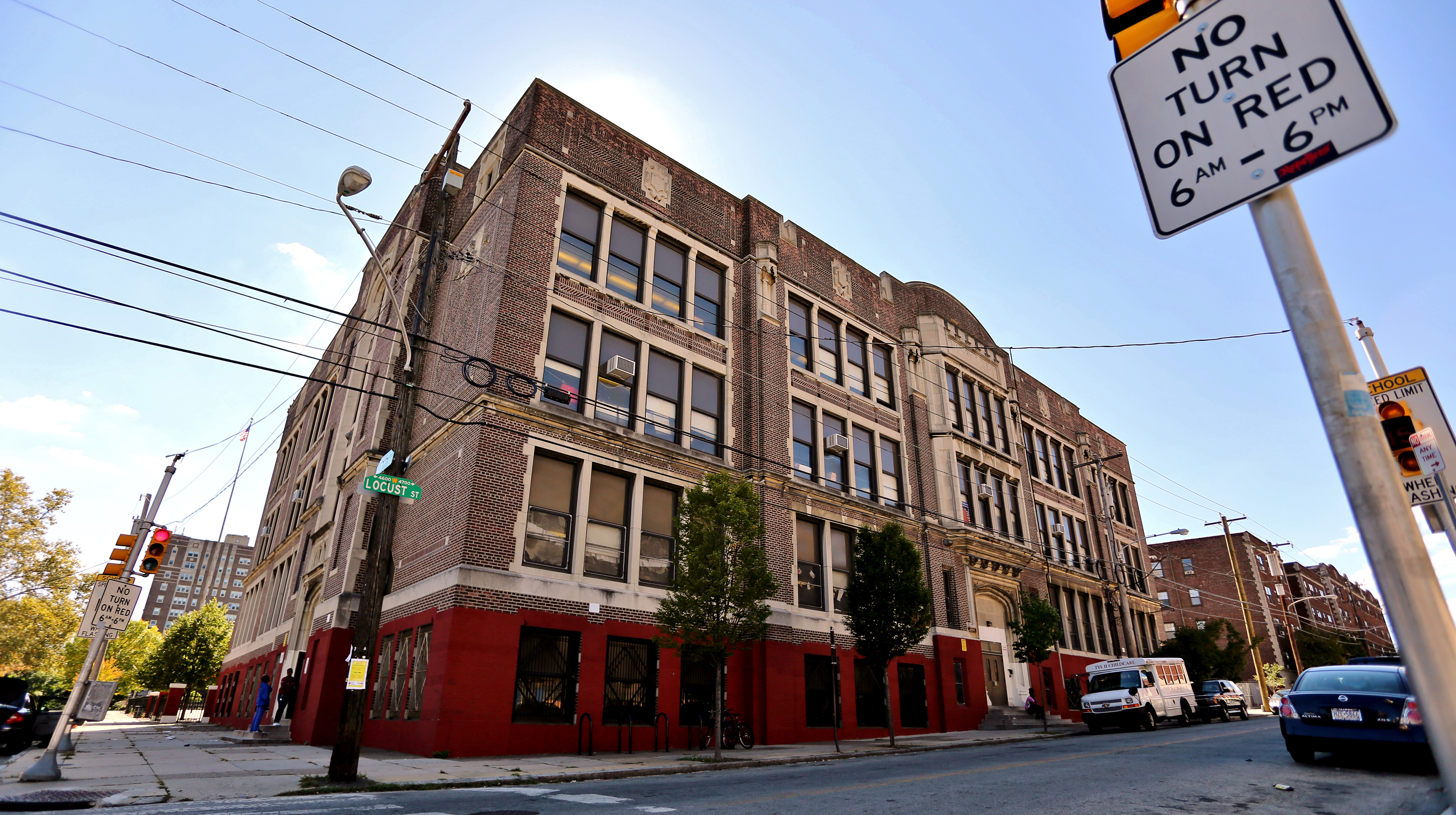 Exterior of the Lea School with Locust street sign on left and No Turn on Red Sign on right