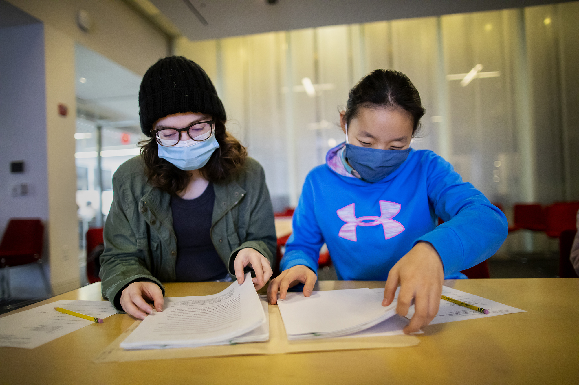 two students looking at manuscripts