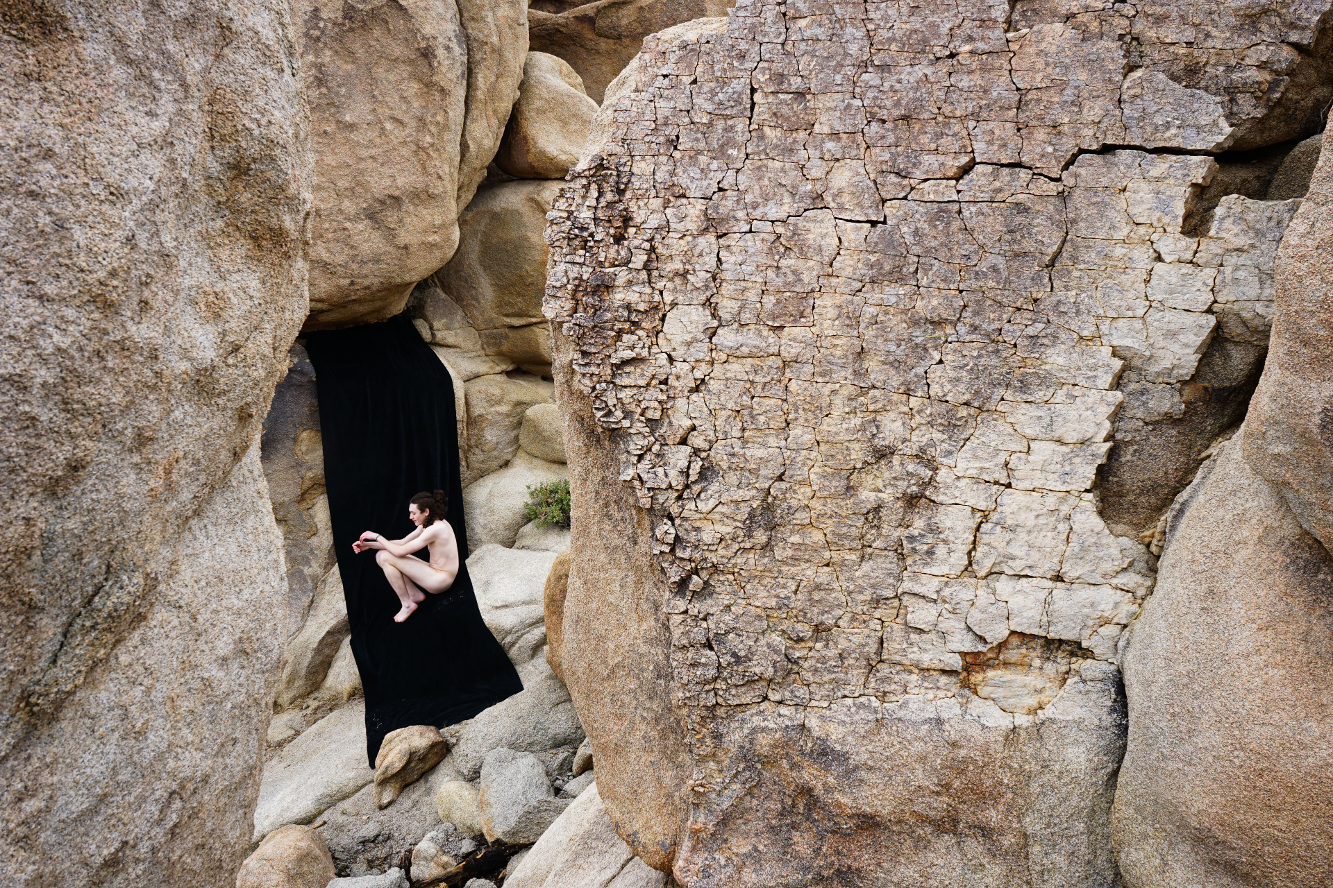 person sitting in a place with rock boulders