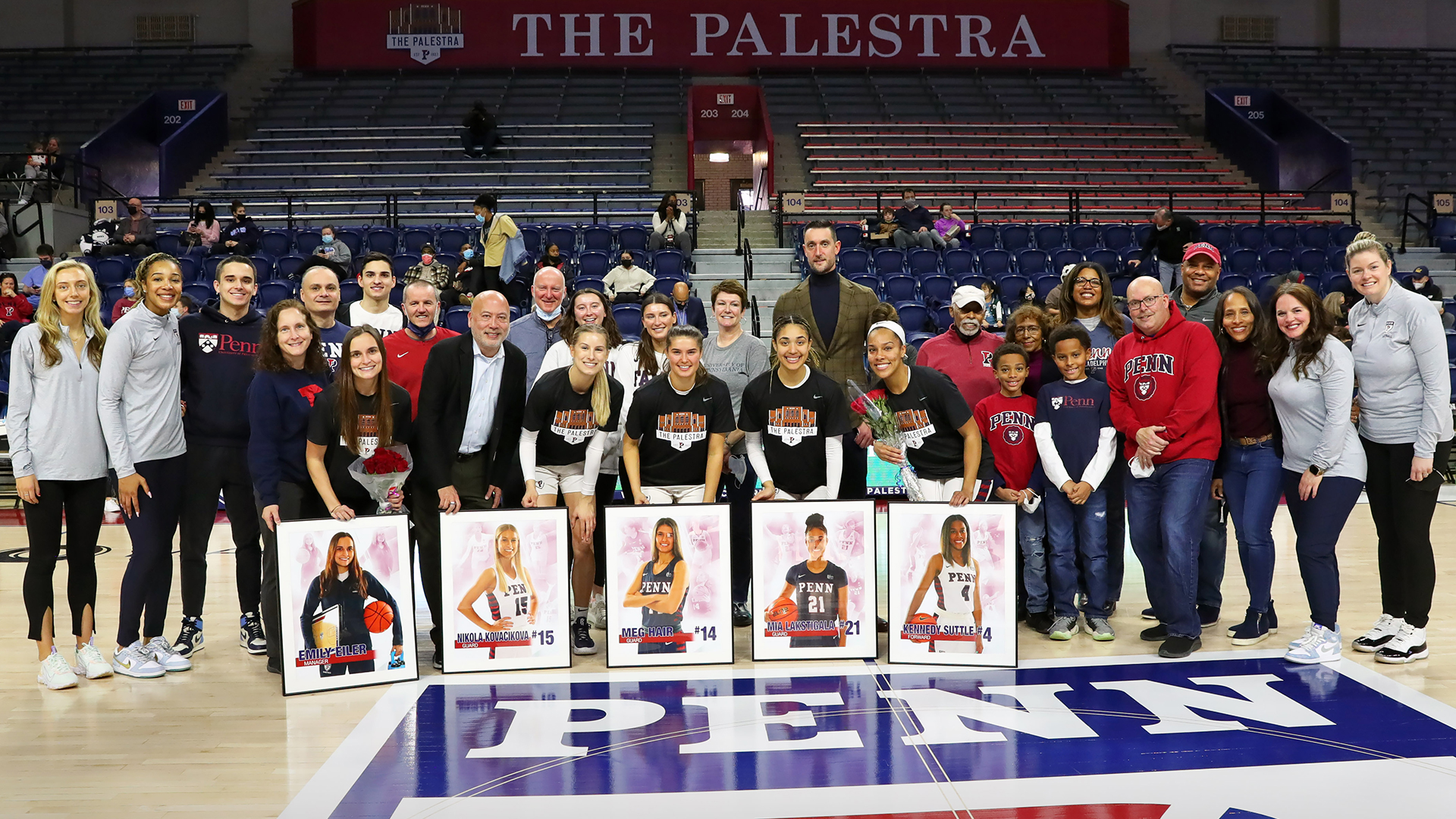 Suttle poses with parents, family, and coaches on Senior Night at the Palestra.