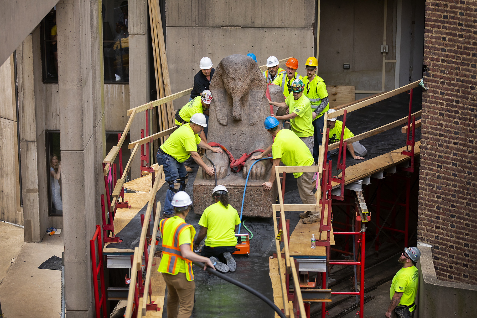 sphinx being moved by several people on a ramp