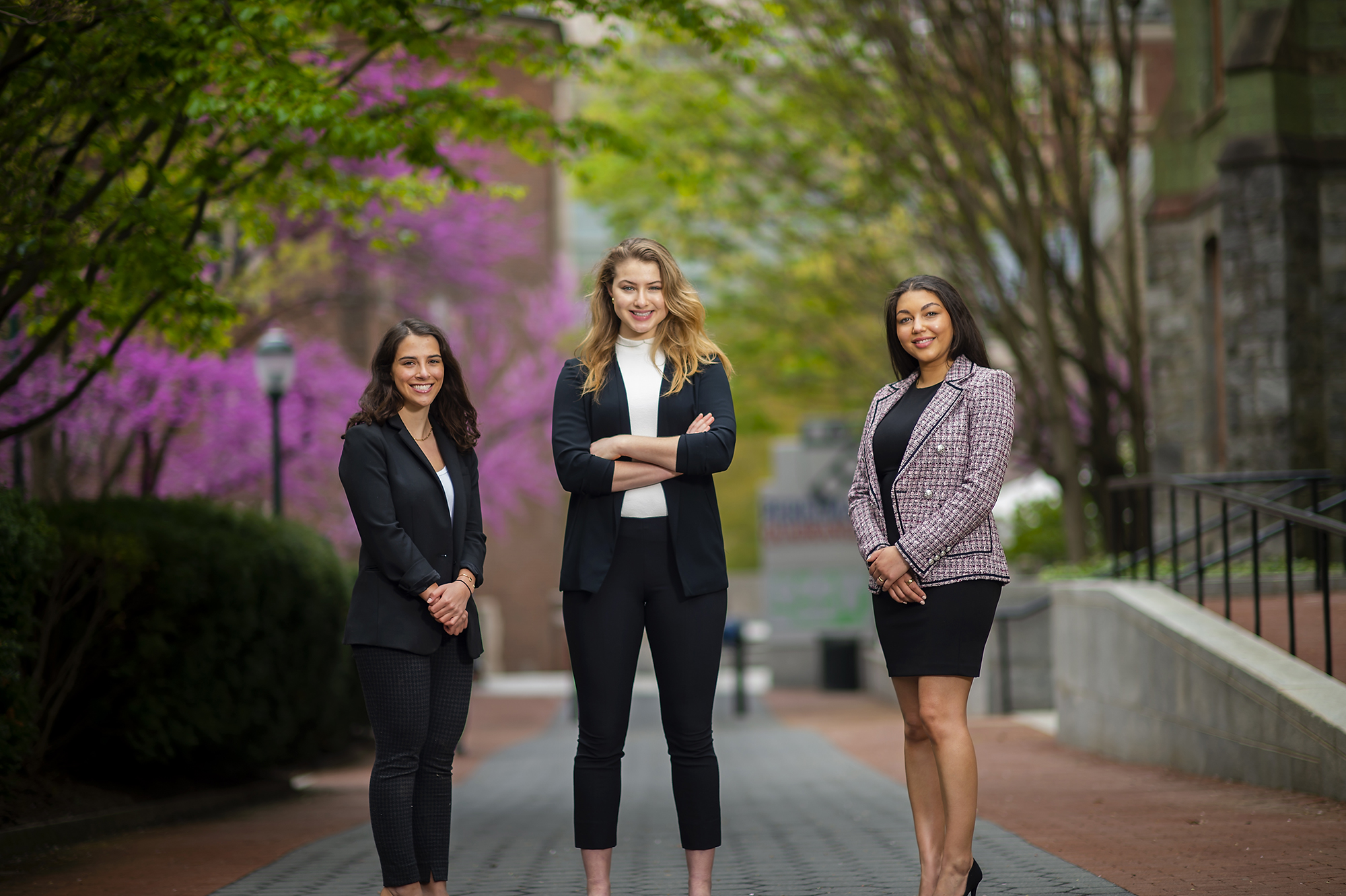 Three members of Project HOPE stand on Locust Walk