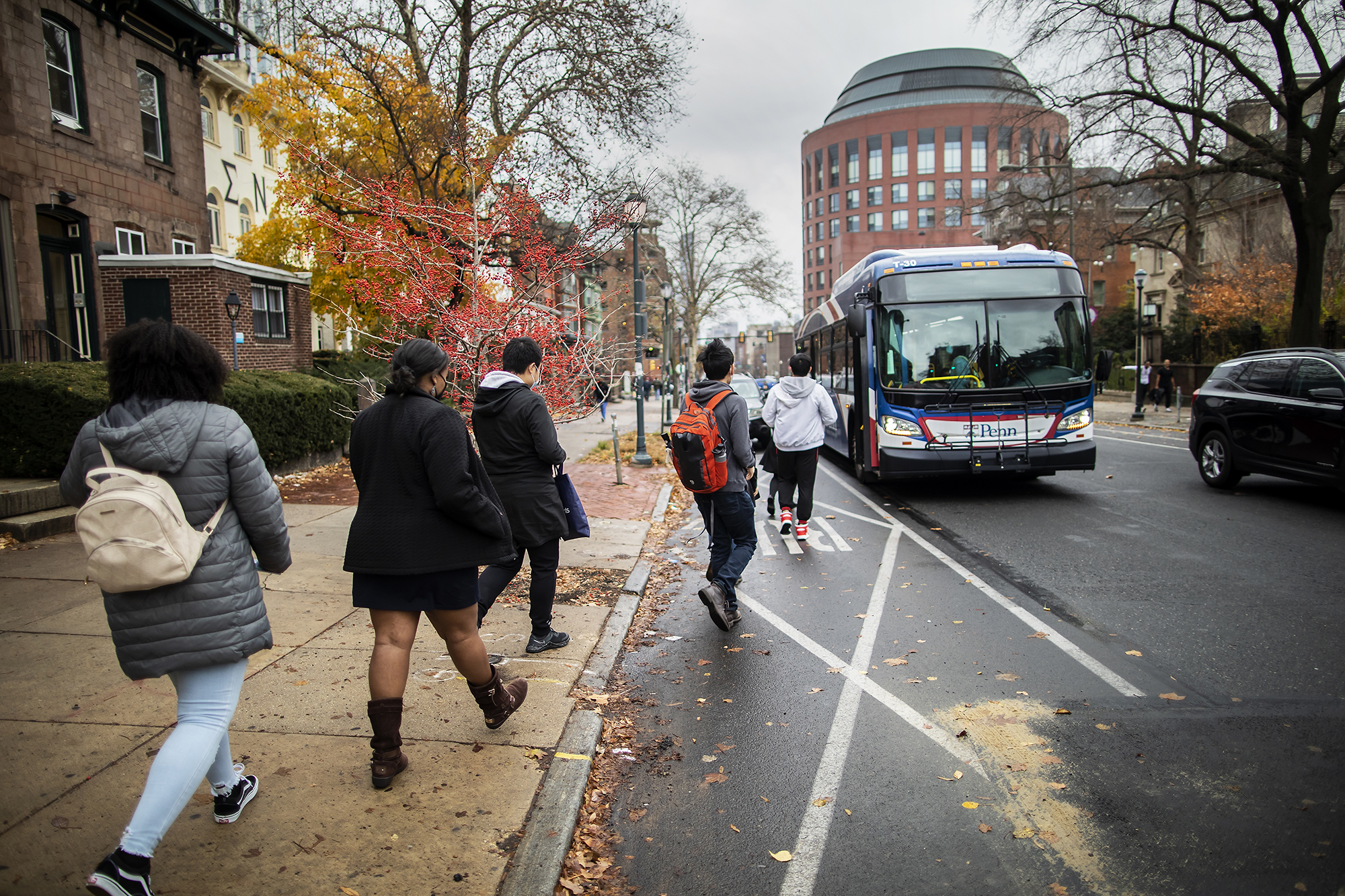 Students line up to get on a Penn charter bus