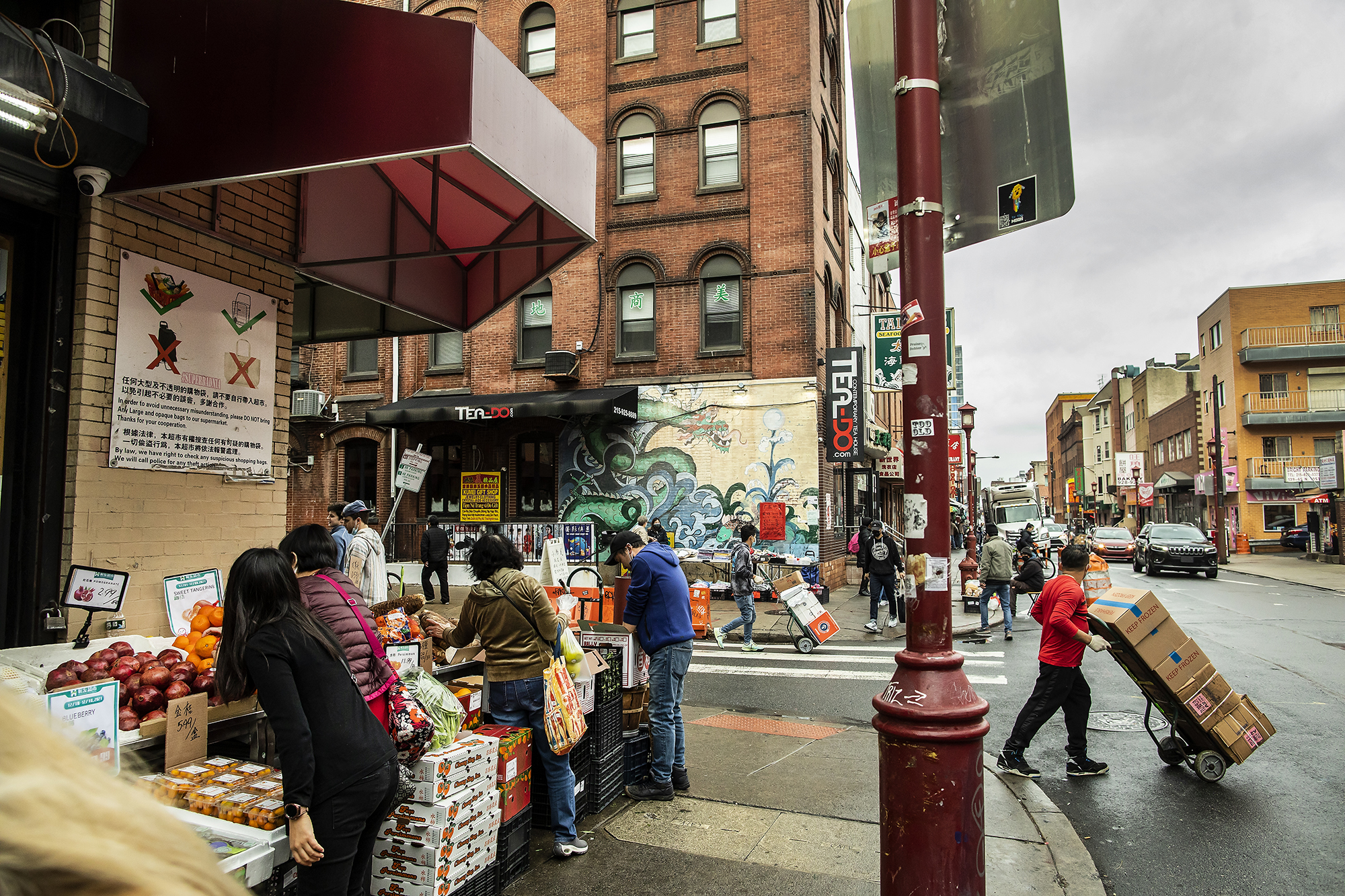 People shop at an open air market in Chinatown