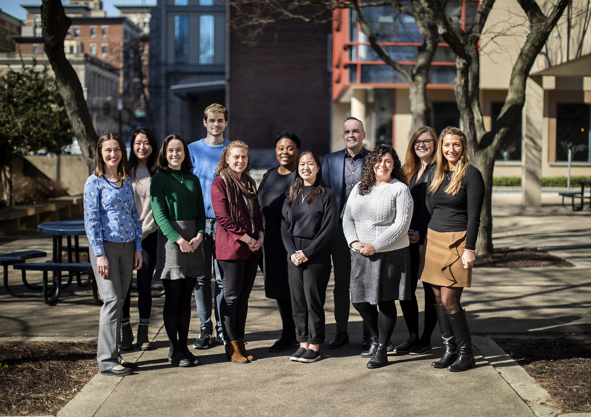 A group of people affiliated with Penn Abroad stand in front of a building on Penn’s campus.