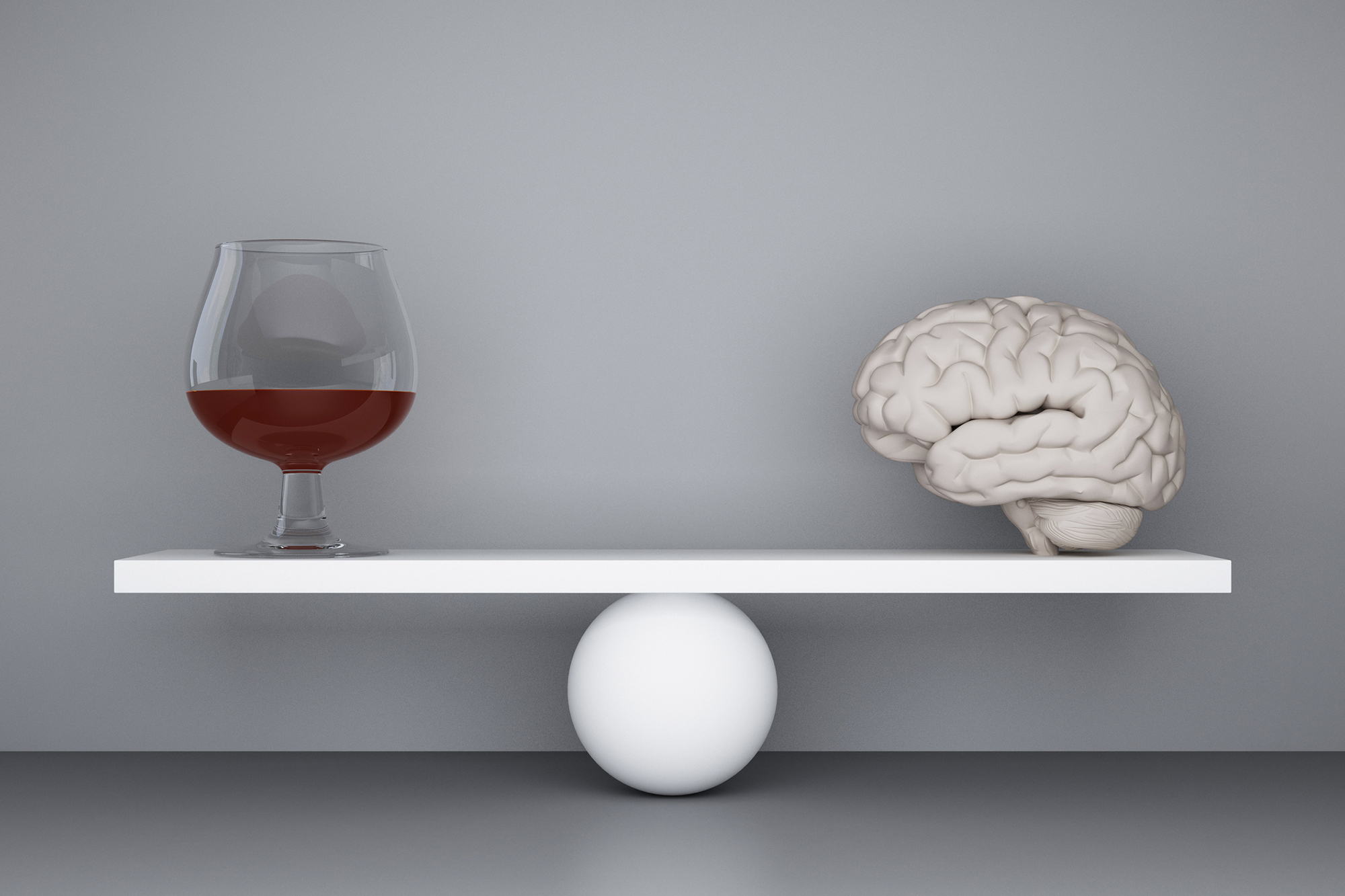 A scale with an alcoholic beverage on one side and a brain on the other