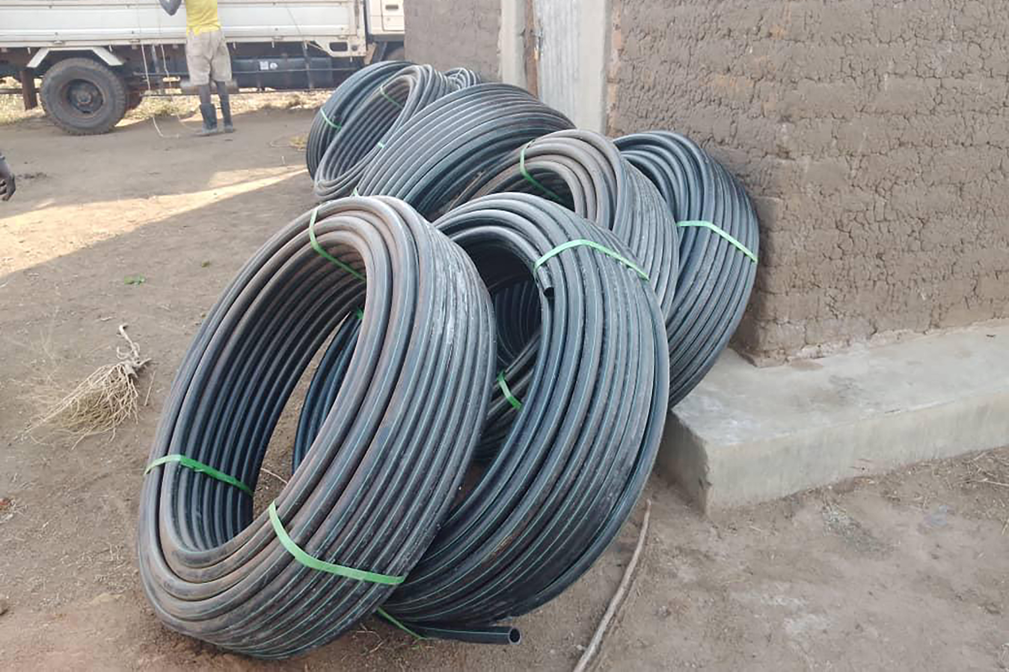 Coiled building material leaning against a wall in Uganda.