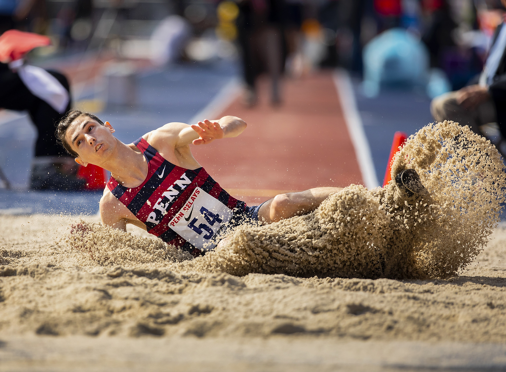 A Penn jumper lands in the dirt after the triple jump.