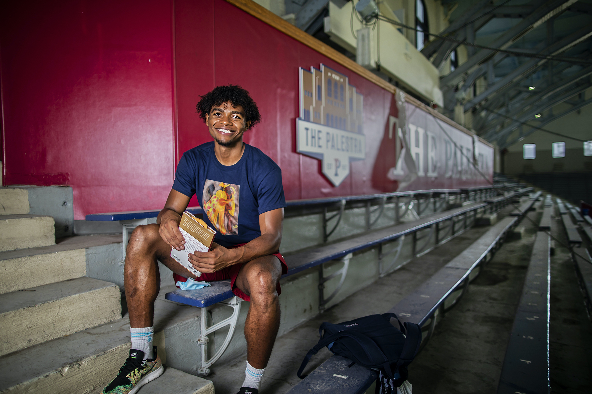 Lucas Monroe sits in the bleachers at the Palestra.