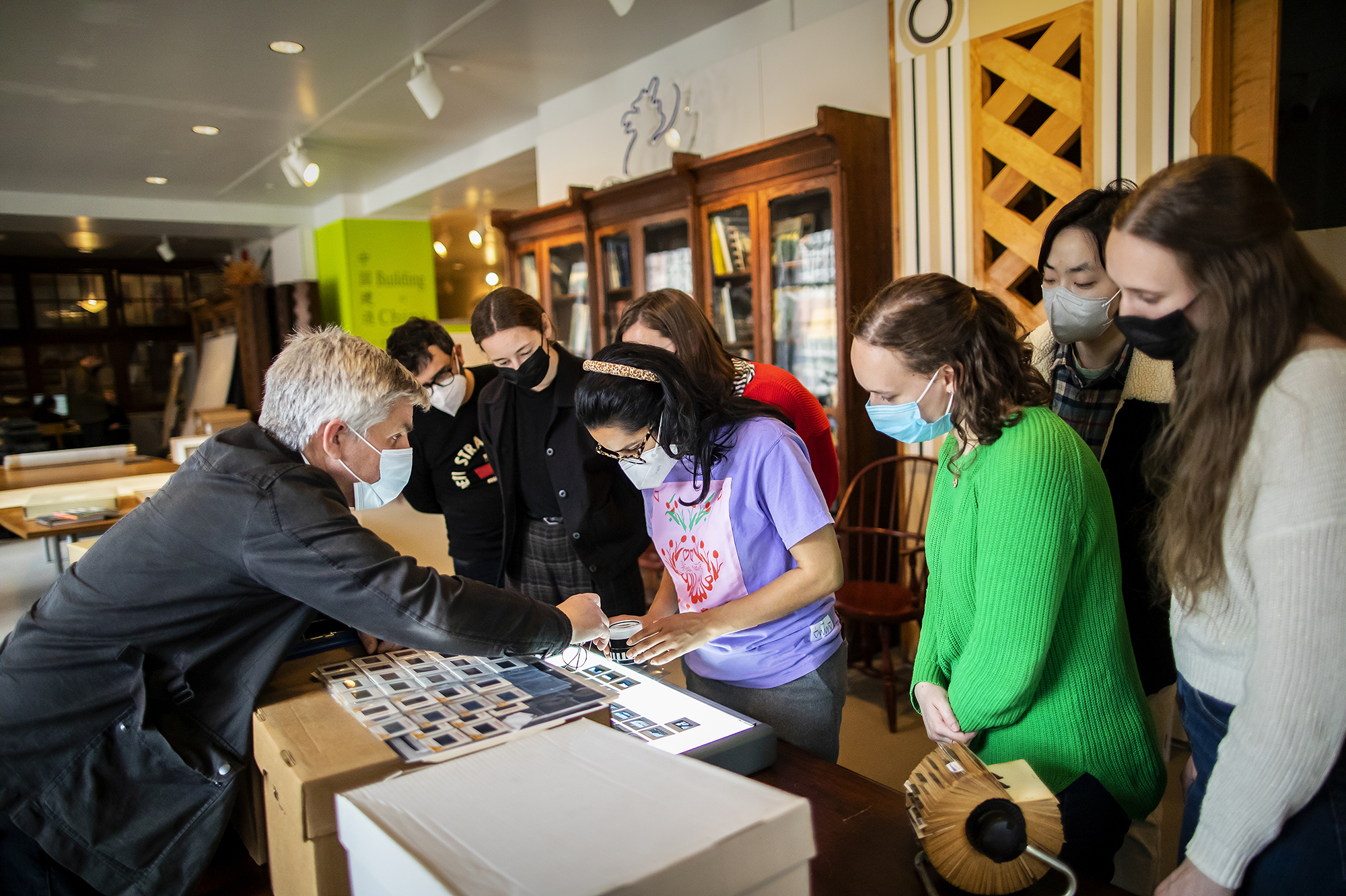 students examine slides from the archive