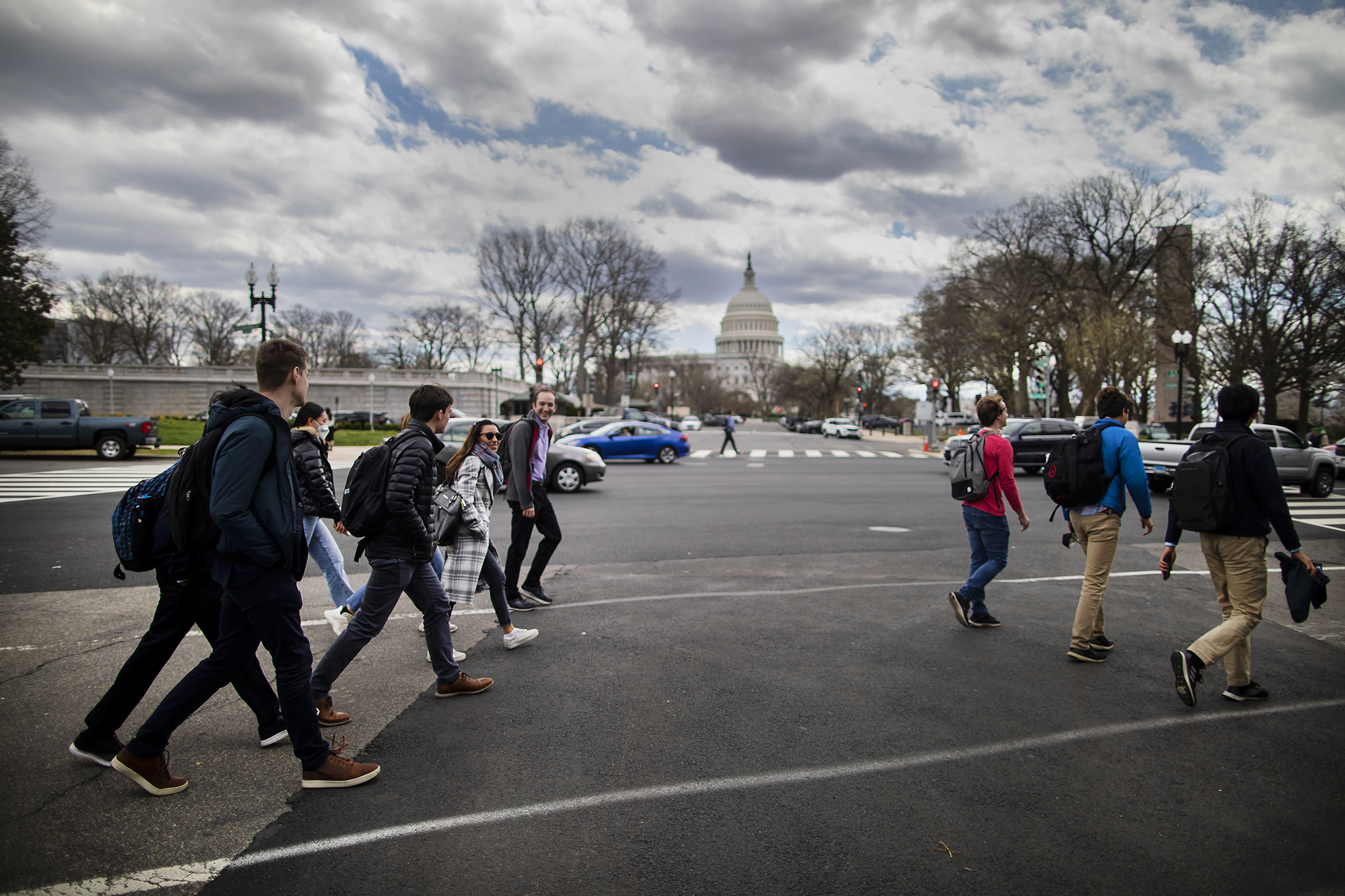 students walk in front of the capitol building before class