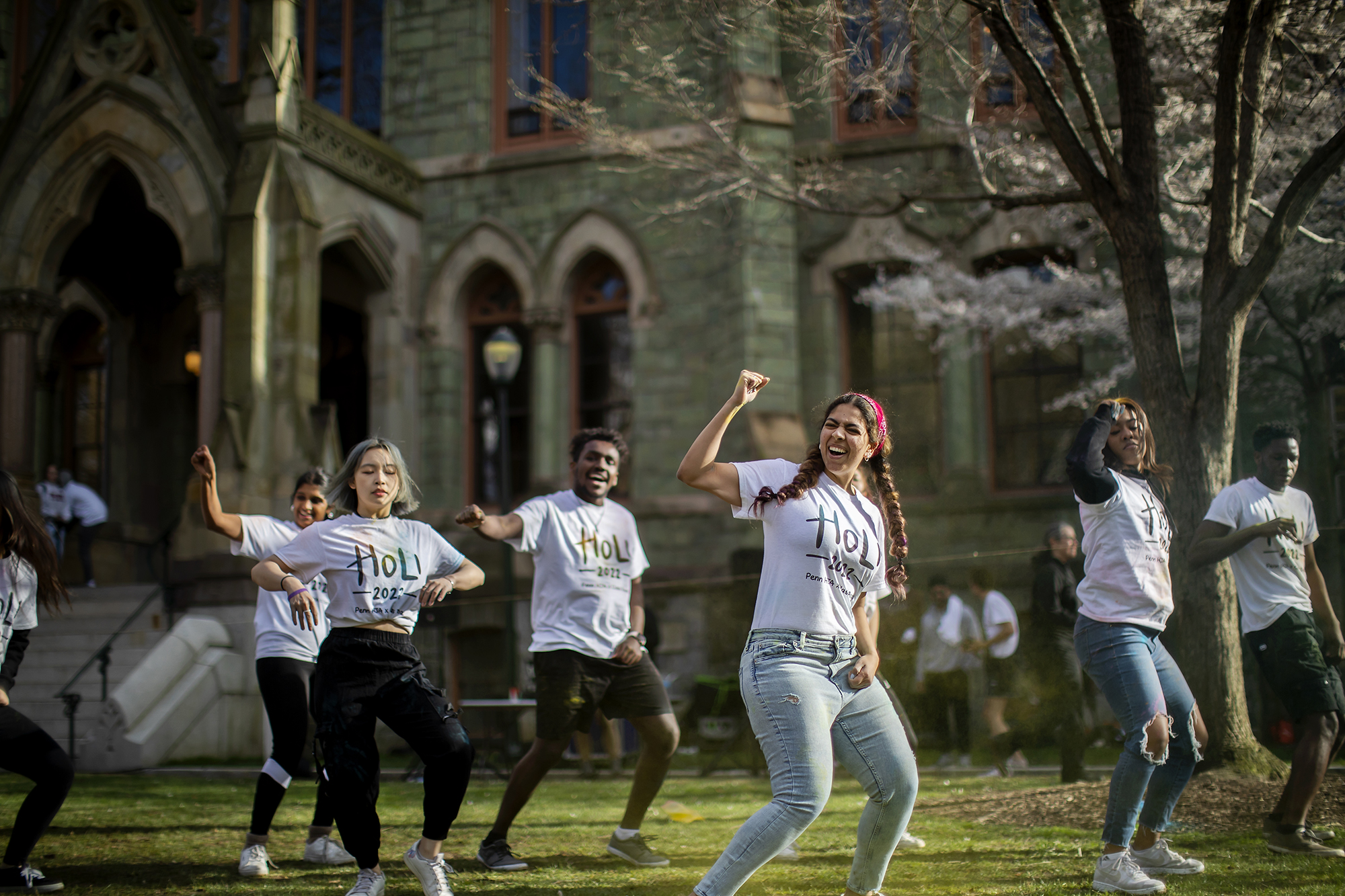 Six performers dancing in front of College Hall for Penn’s Holi celebration.