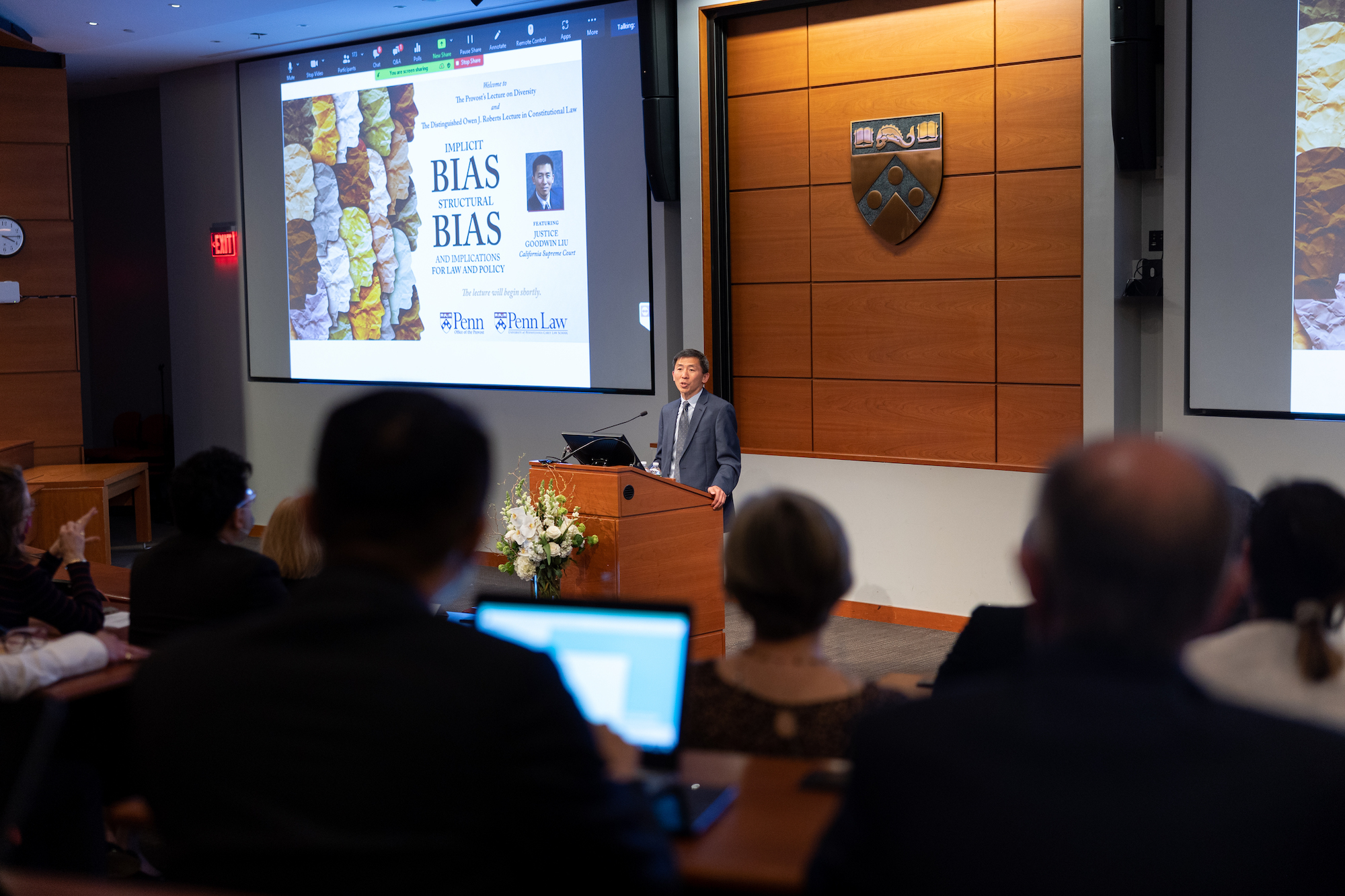 Justice Goodwin Liu speaks at a podium in the University of Pennsylvania Carey School of Law