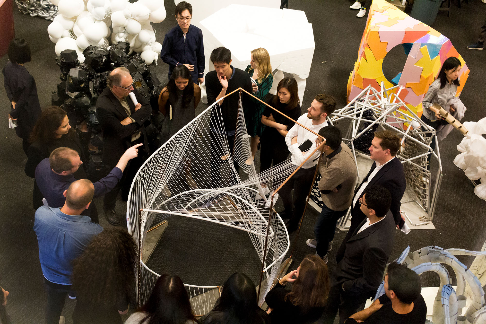 As seen from above, people gathered around structural designs at a party or event.