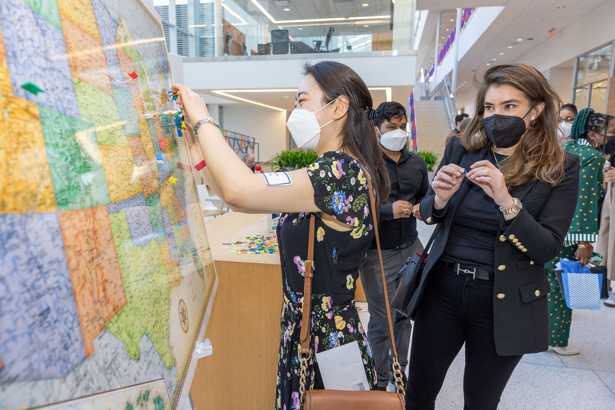 A Penn Med student puts a pin in a large map displayed for Match Day.