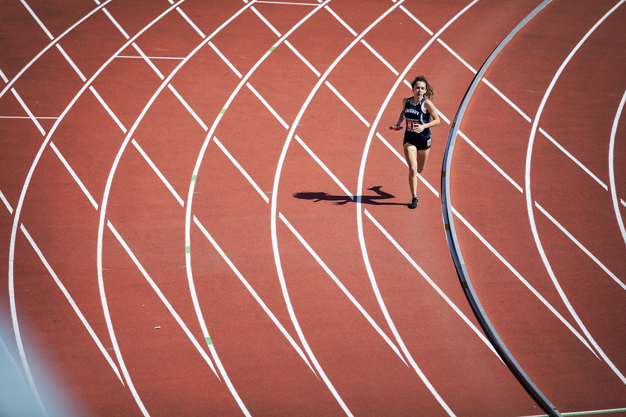 A solo runner running on a track.
