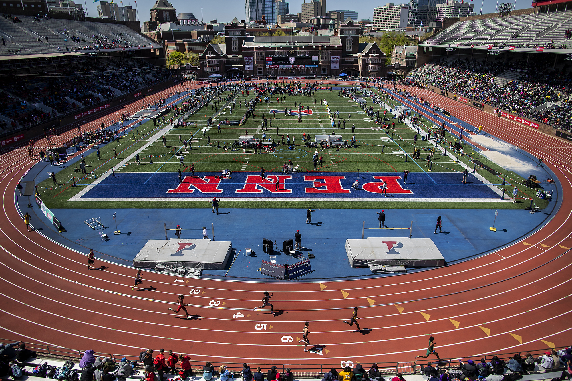 Full view of Penn’s Franklin Field with runners running on the track.