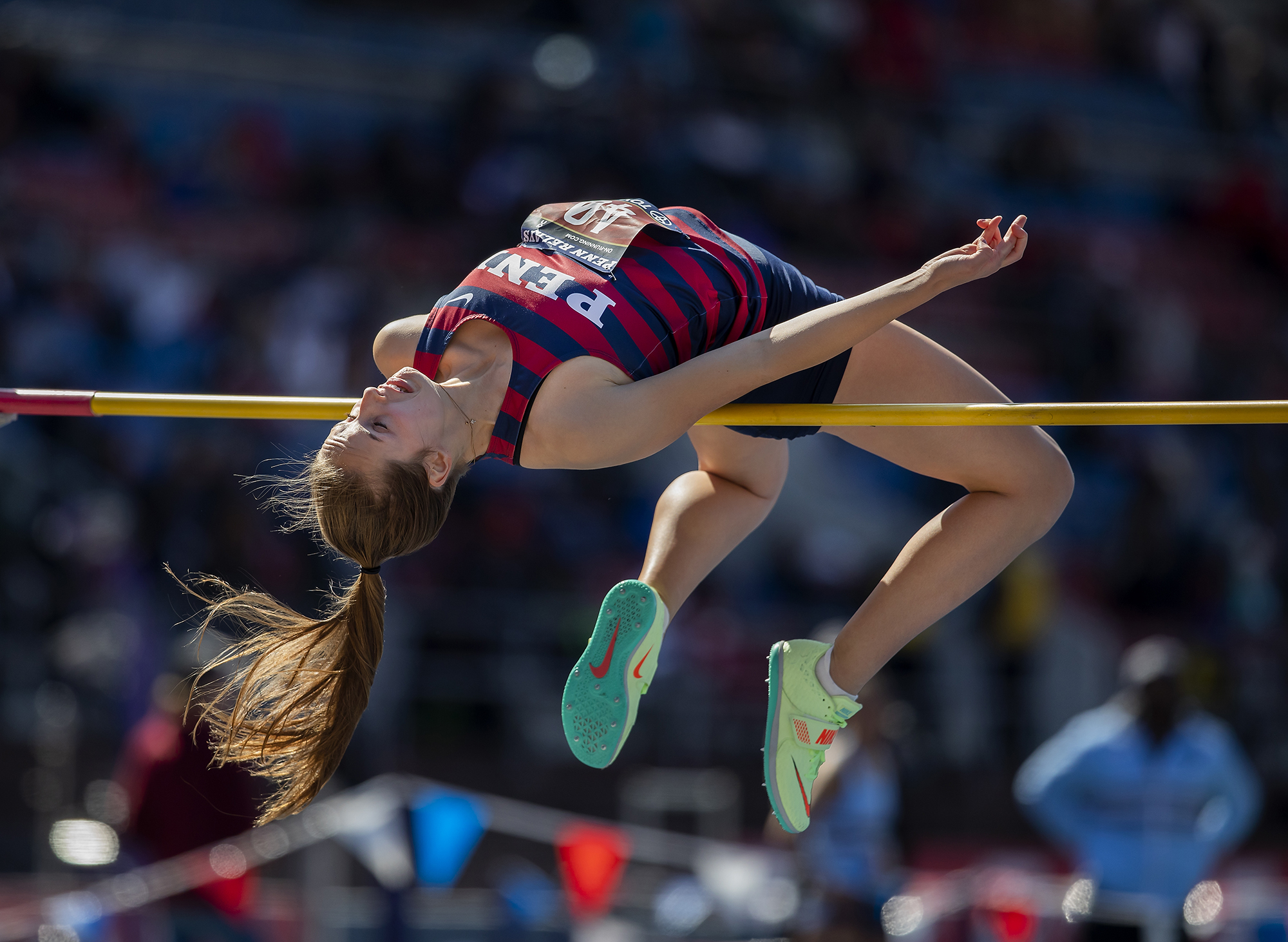 A person arching over a high jump bar in mid-air.