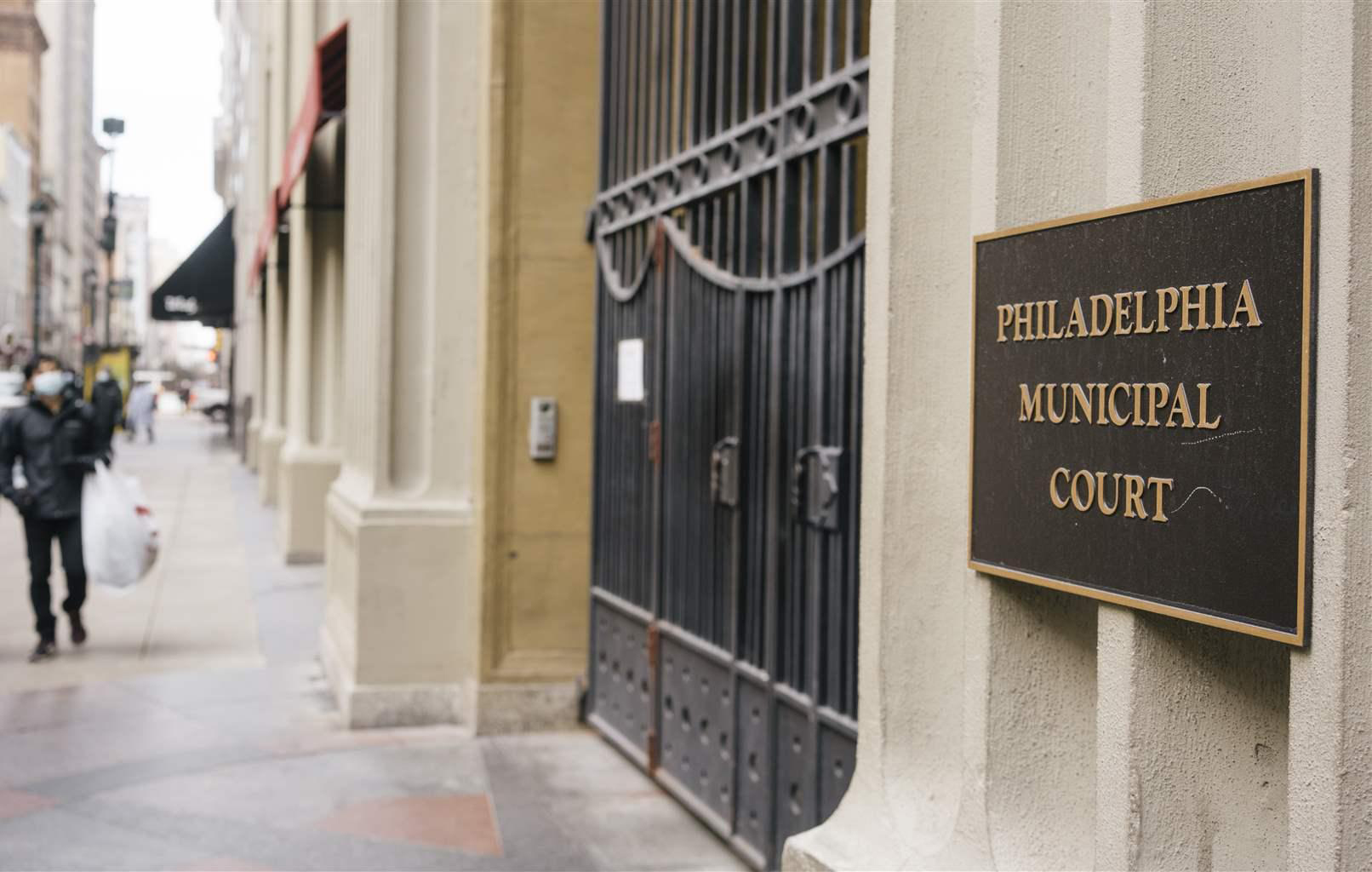 Sidewalk entrance for Philadelphia Municipal Court with plaque at gate.
