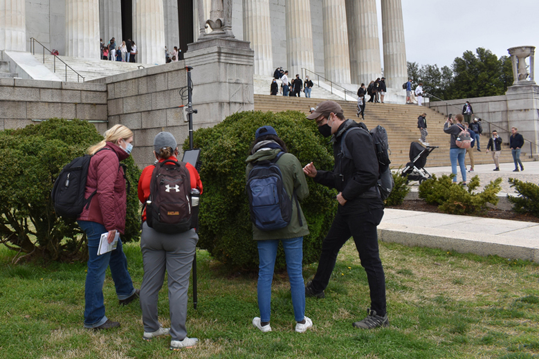 Four Weitzman students in the grass in front of the Lincoln Memorial.