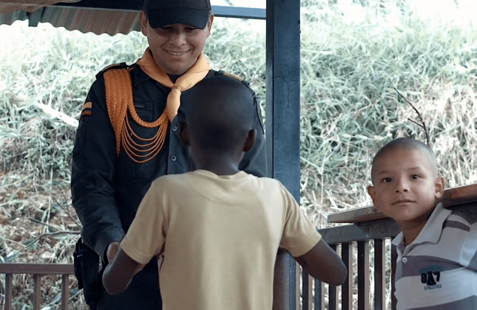 Film still of two Colombian children meeting an ex-FARC member.